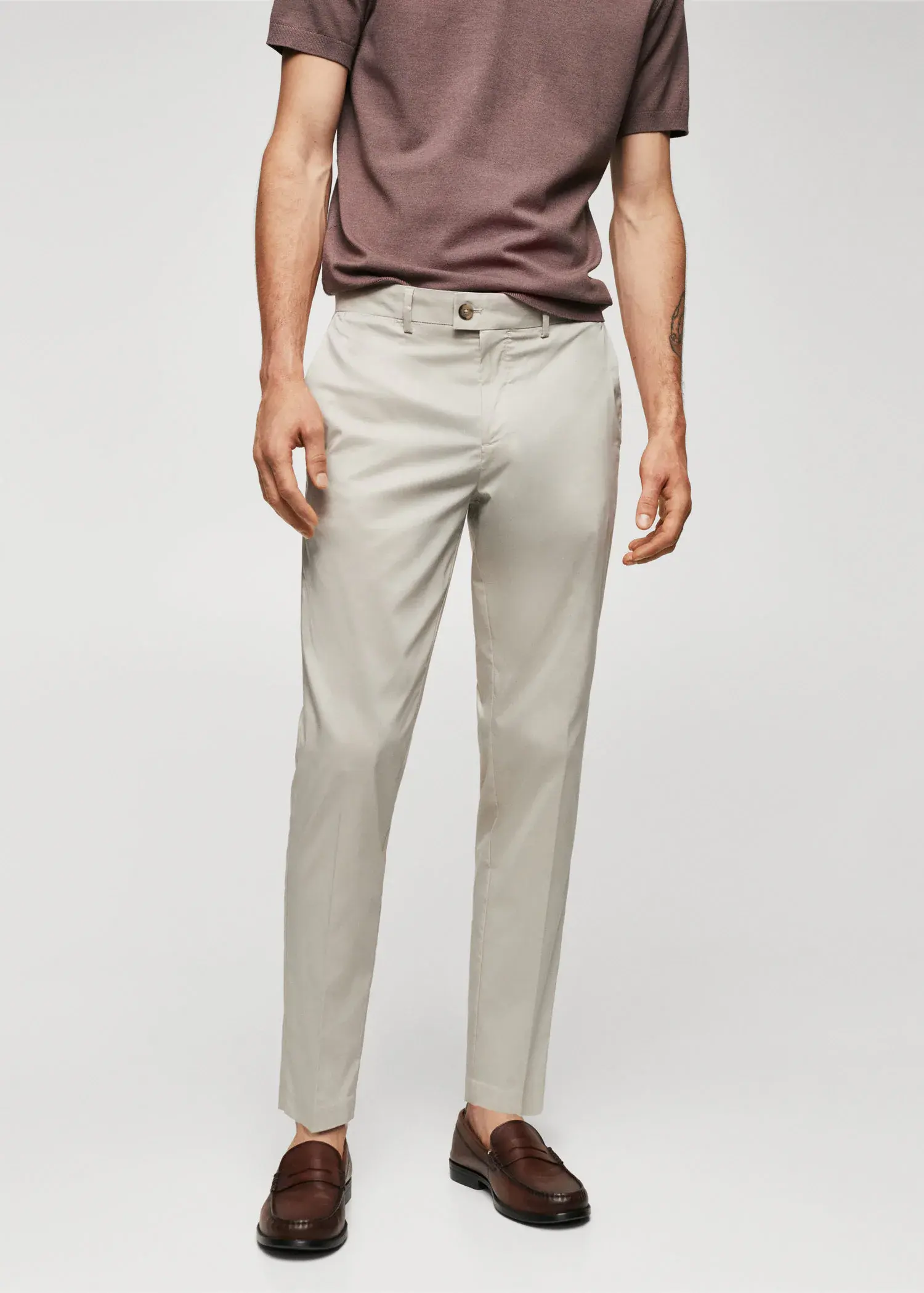 Mango Lightweight cotton trousers. a man wearing a tan shirt and a pair of white pants. 