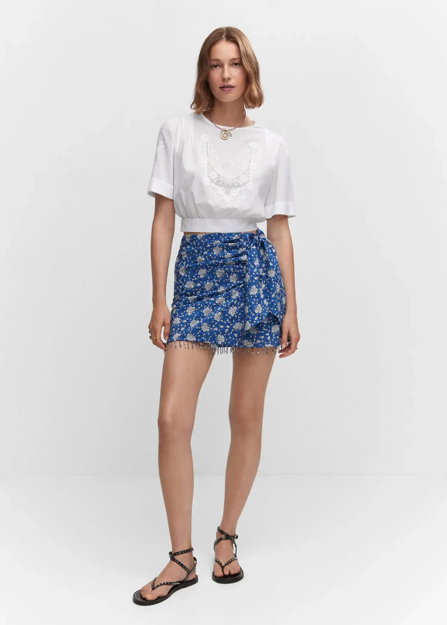 Mango Embroidered crop top. a woman in a white shirt and blue skirt. 