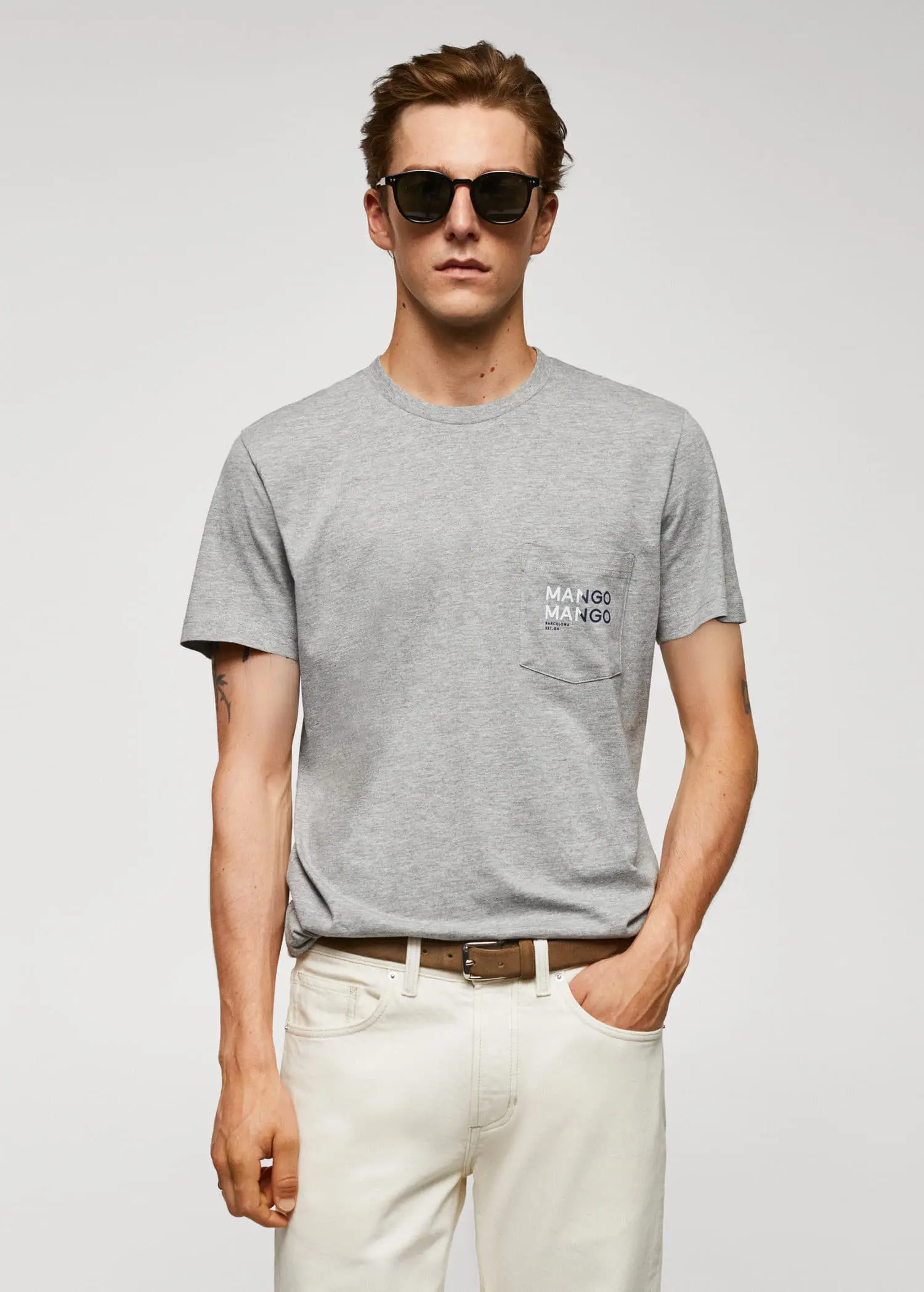 Mango Logo print cotton t-shirt. a young man wearing sunglasses and a gray t-shirt. 