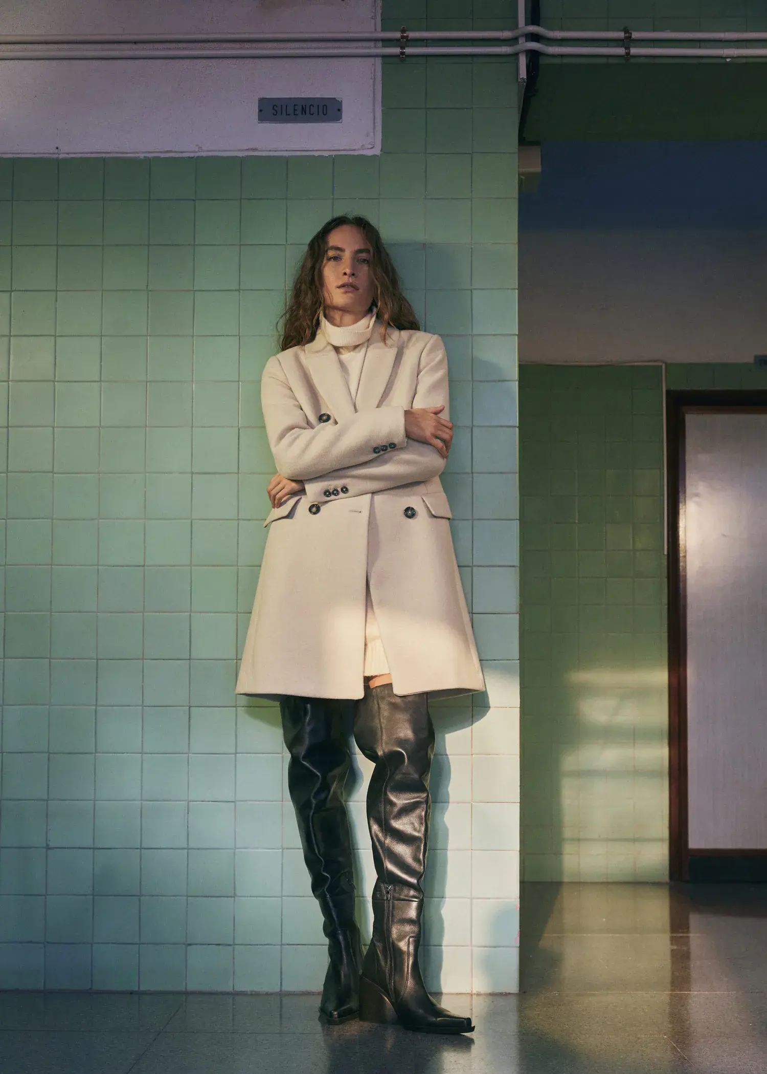 Mango Wool double-breasted coat. a woman in a white coat standing in a room. 