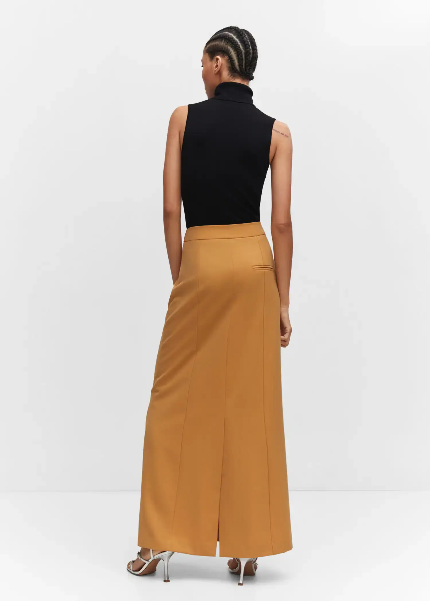 Mango Flowy long skirt. a woman wearing a black top and a long skirt. 