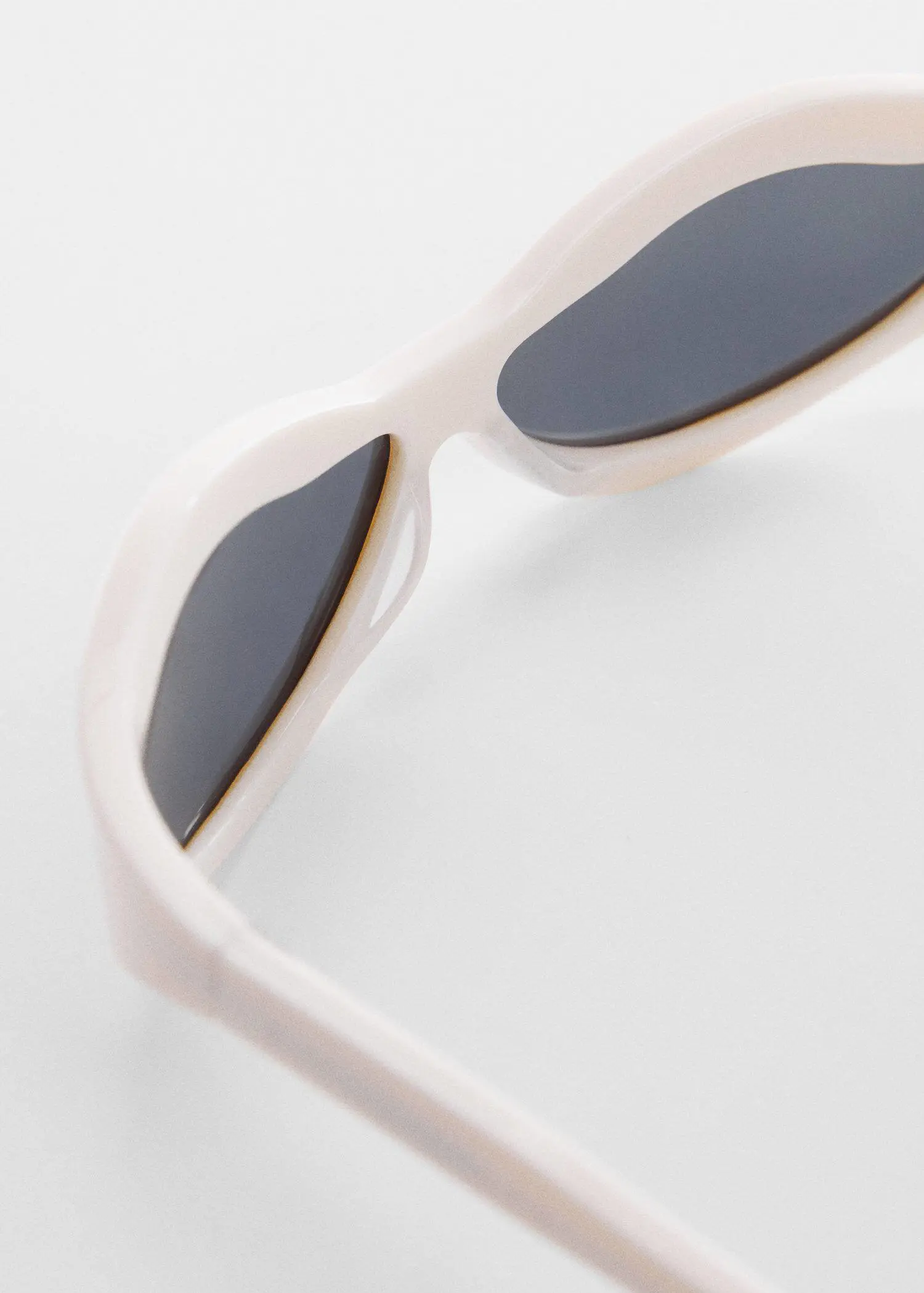 Mango Irregular crystals sunglasses. a close up of a pair of white sunglasses. 