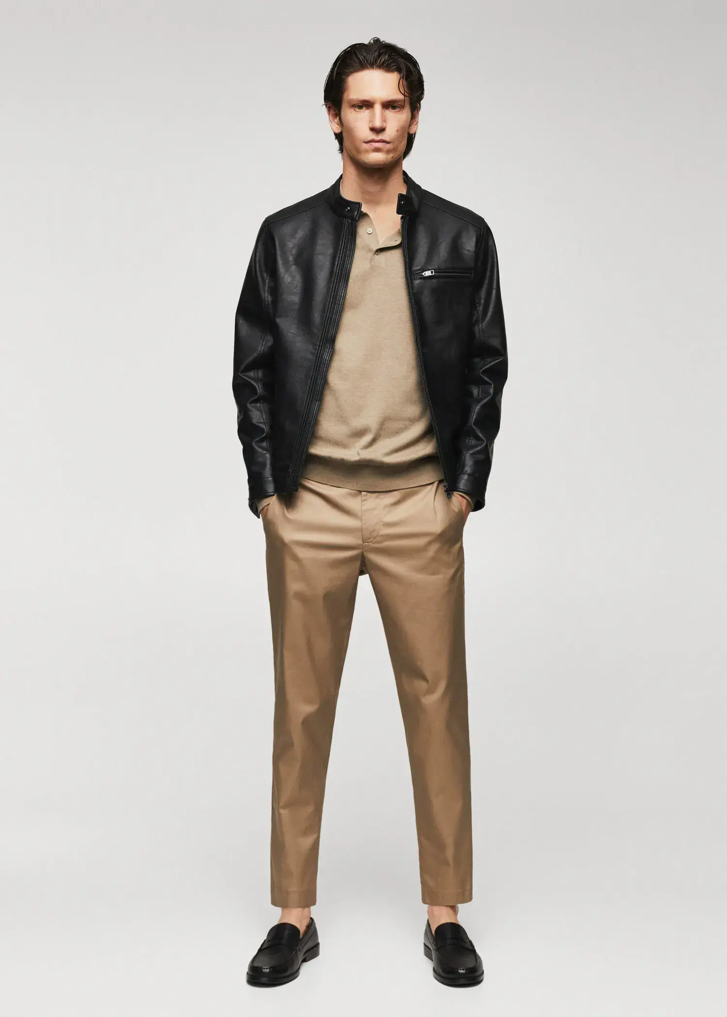 Mango Leather-effect jacket with zips. a man in a black jacket and tan pants. 