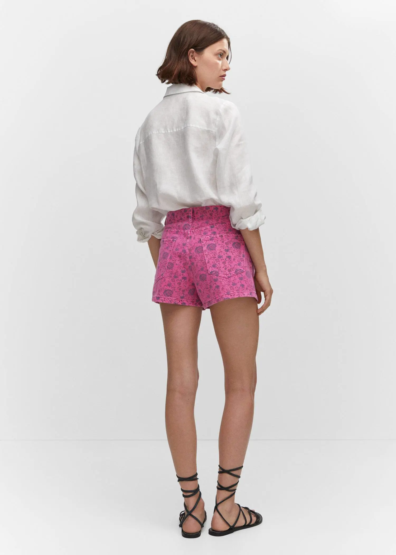 Mango Printed denim shorts. a woman wearing pink shorts and a white shirt. 