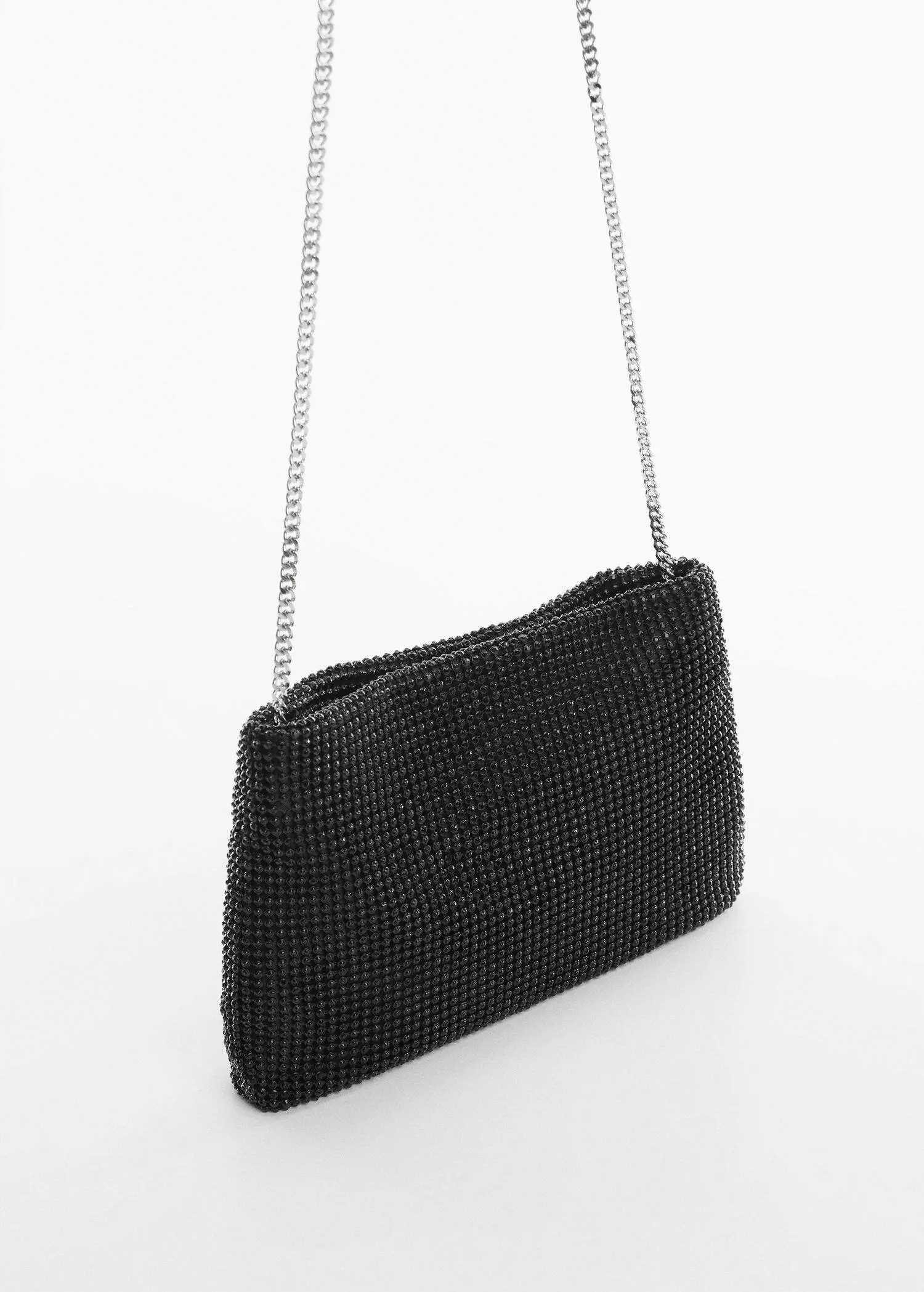 Mango Rhinestone chain bag. a close-up of a black purse on a white surface. 