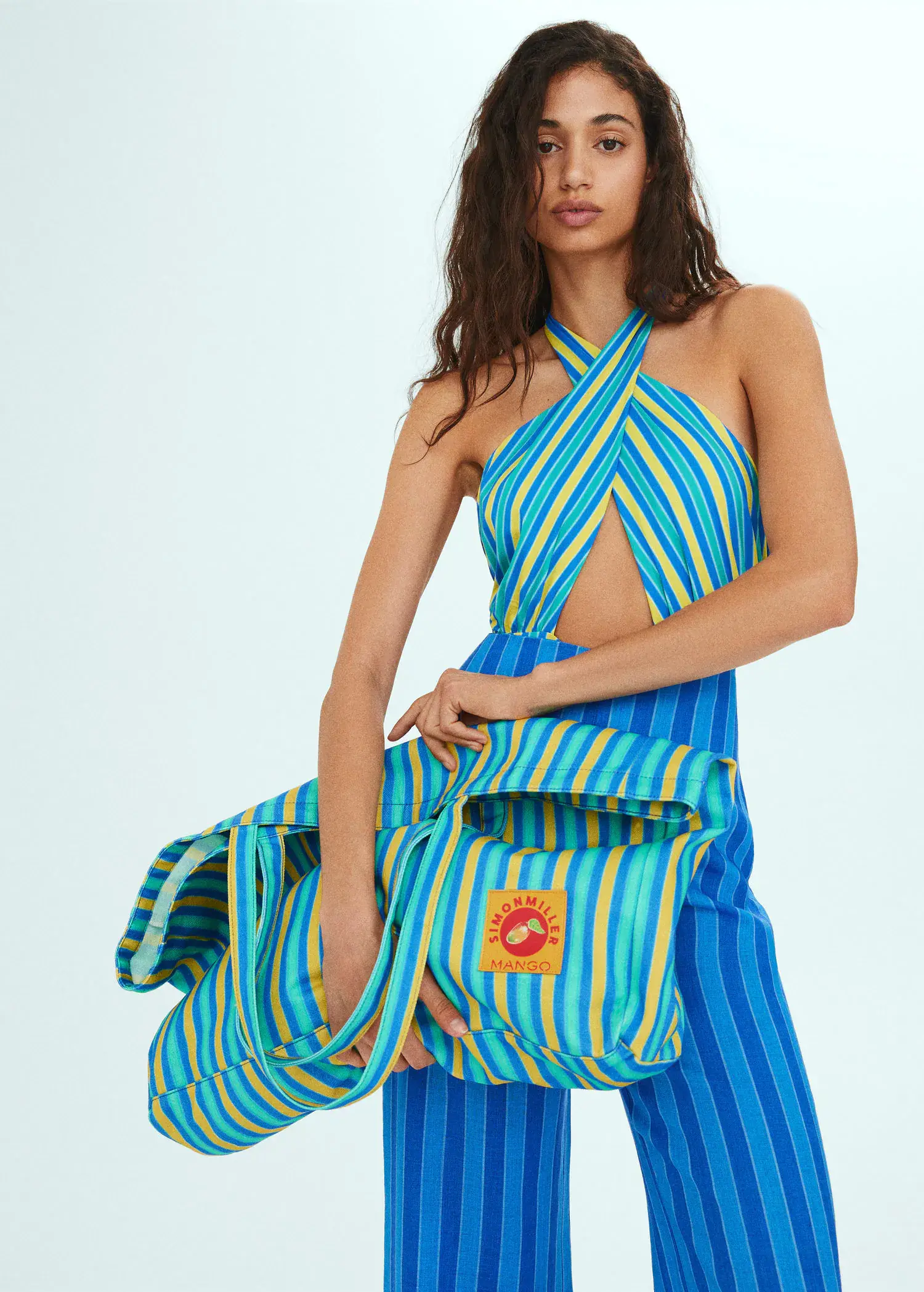 Mango Multi-coloured striped maxi bag. a woman in a blue and yellow striped outfit. 