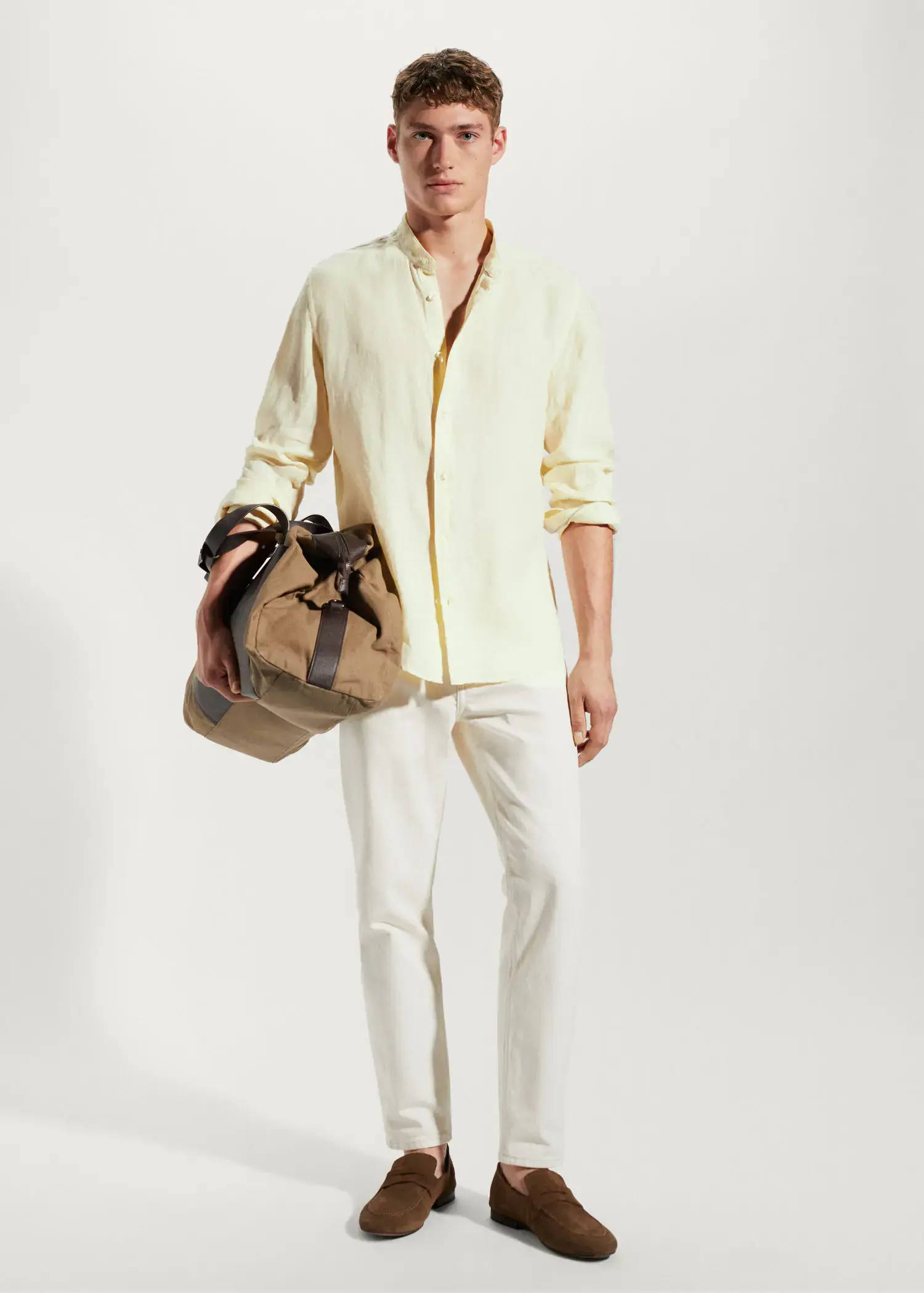 Mango 100% linen Mao collar shirt. a man in a yellow shirt holding a brown bag. 