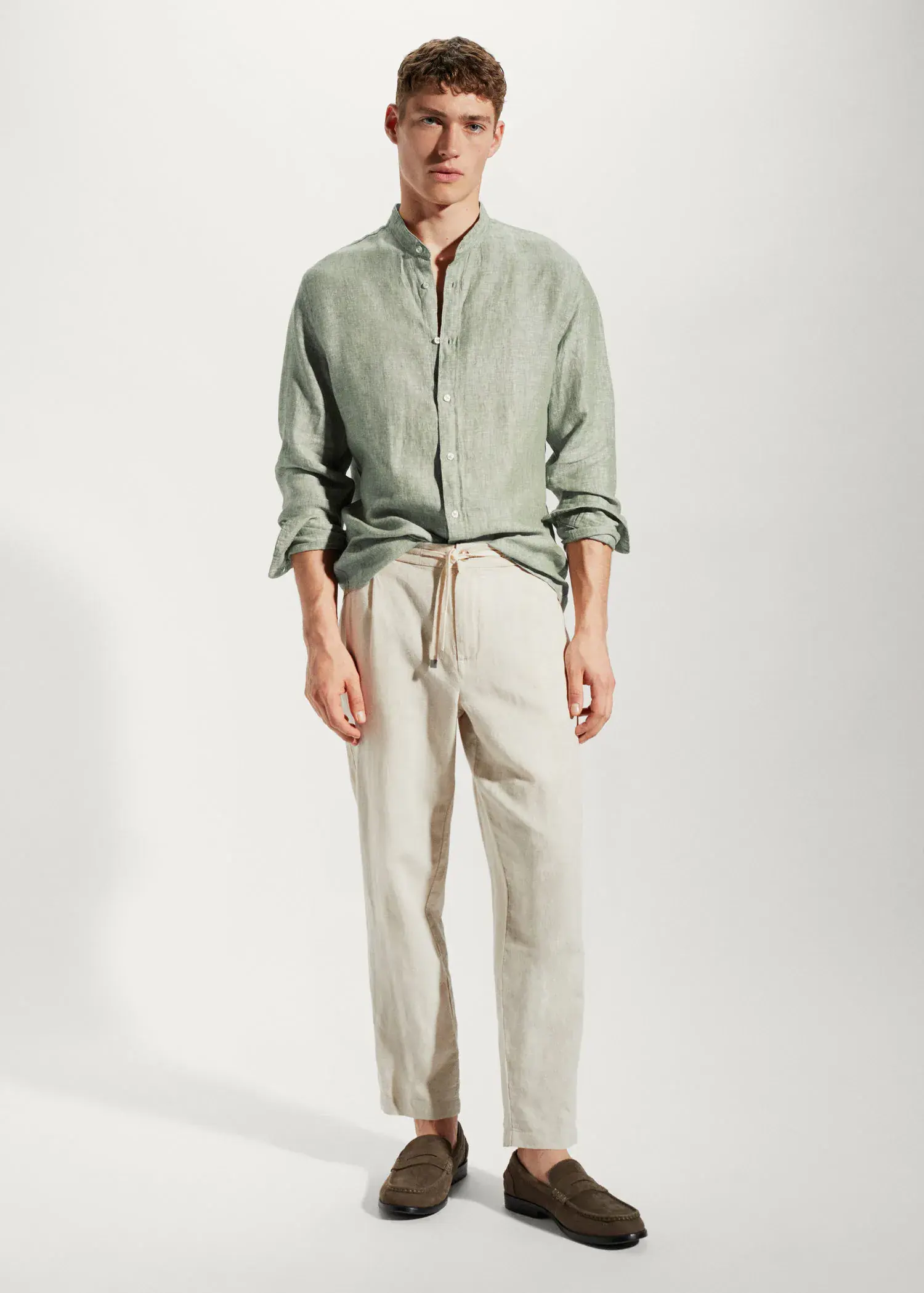 Mango 100% linen Mao collar shirt. a man wearing a green shirt and beige pants. 