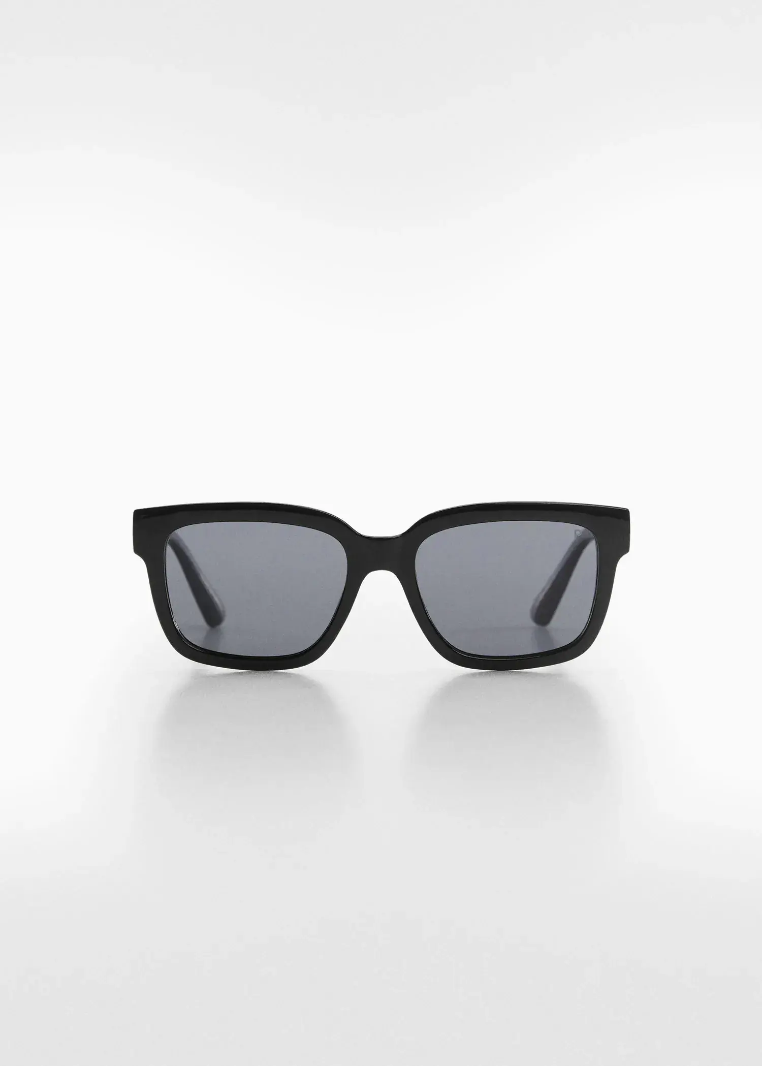 Mango Polarised sunglasses. a pair of sunglasses on a white surface. 