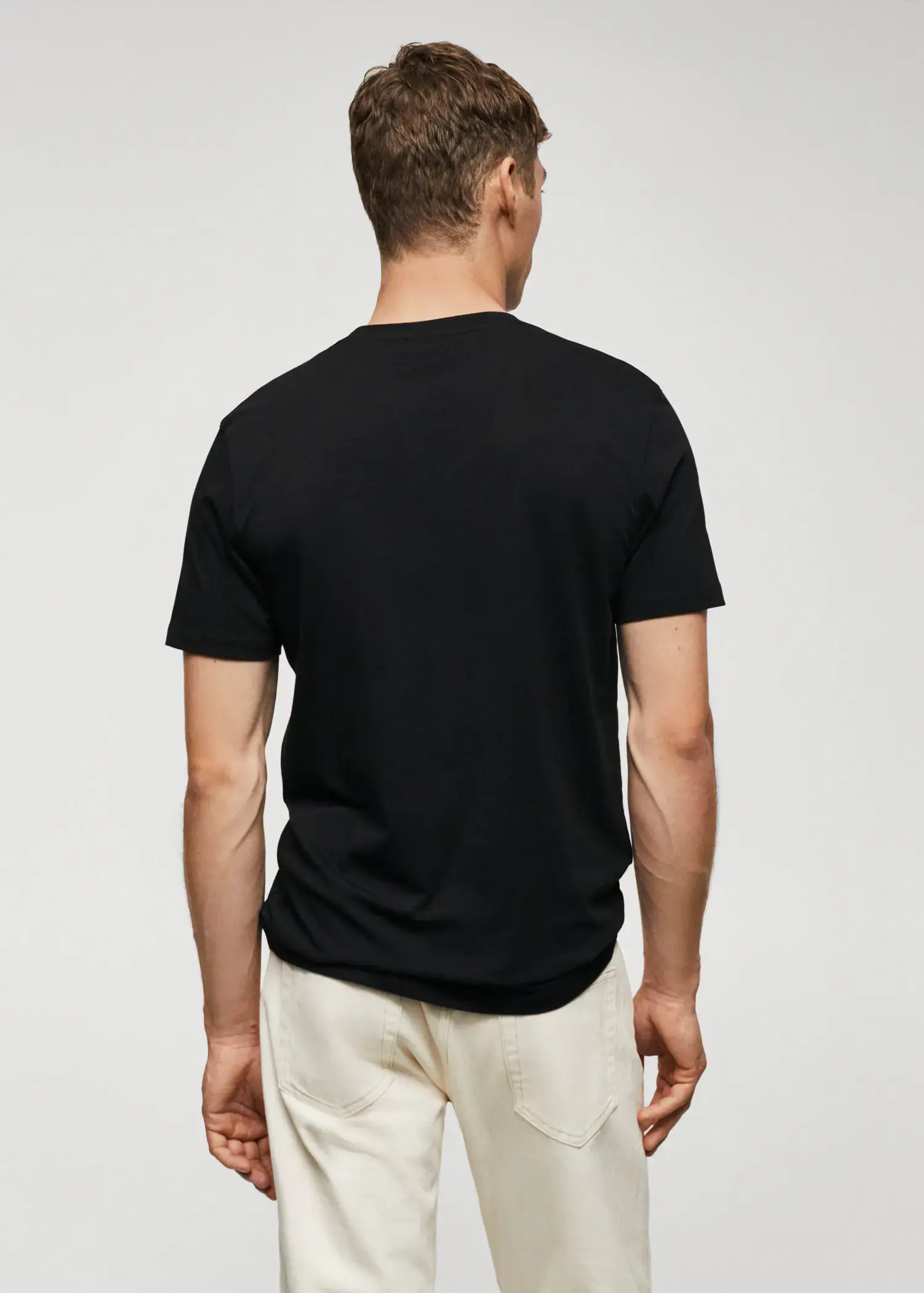 Mango Basic lightweight cotton t-shirt. a man wearing a black shirt and white shorts. 