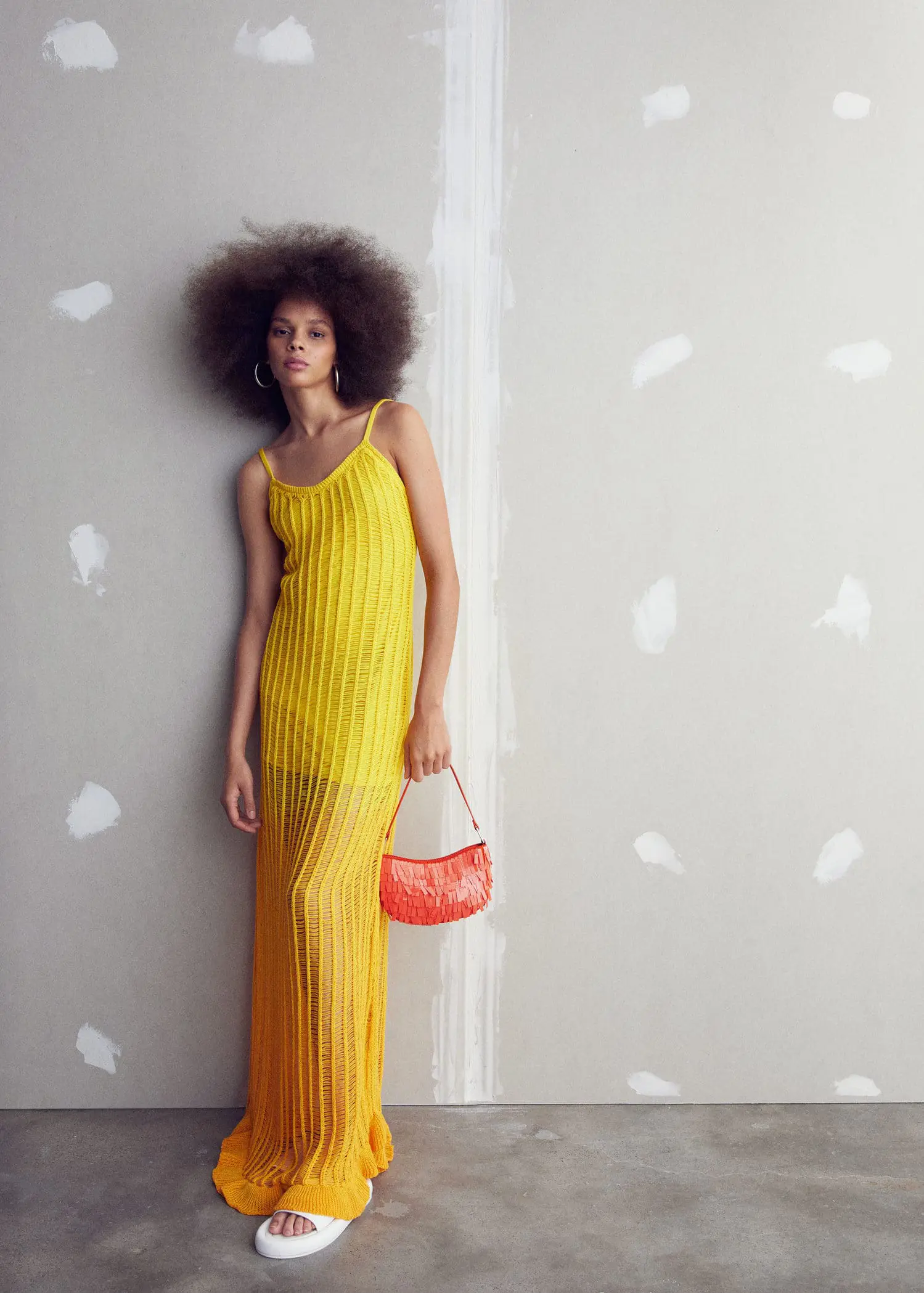 Mango Fringed shoulder bag. a woman in a yellow dress holding a purse. 