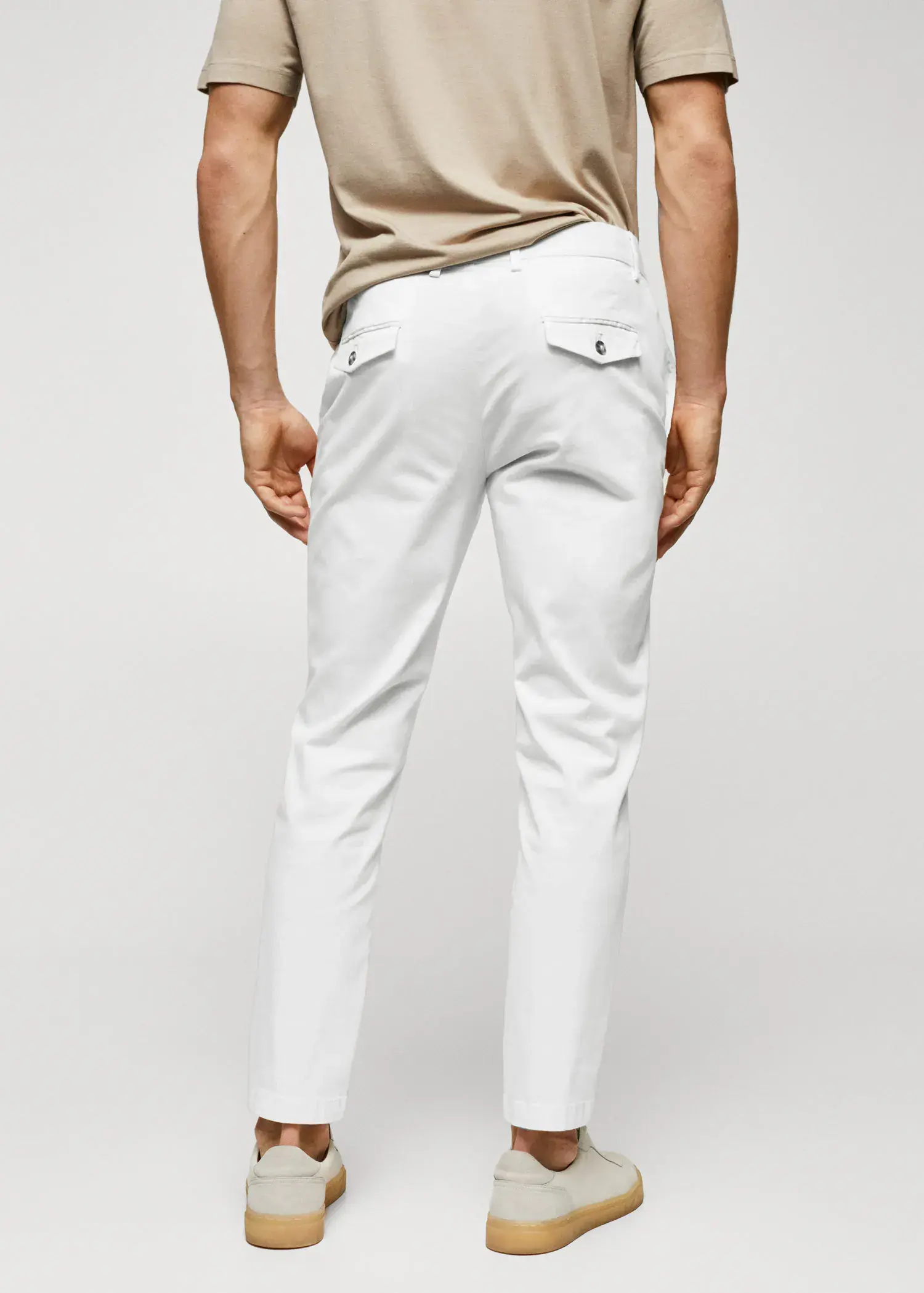 Mango Cotton tapered crop pants. a man wearing white pants and a tan shirt. 