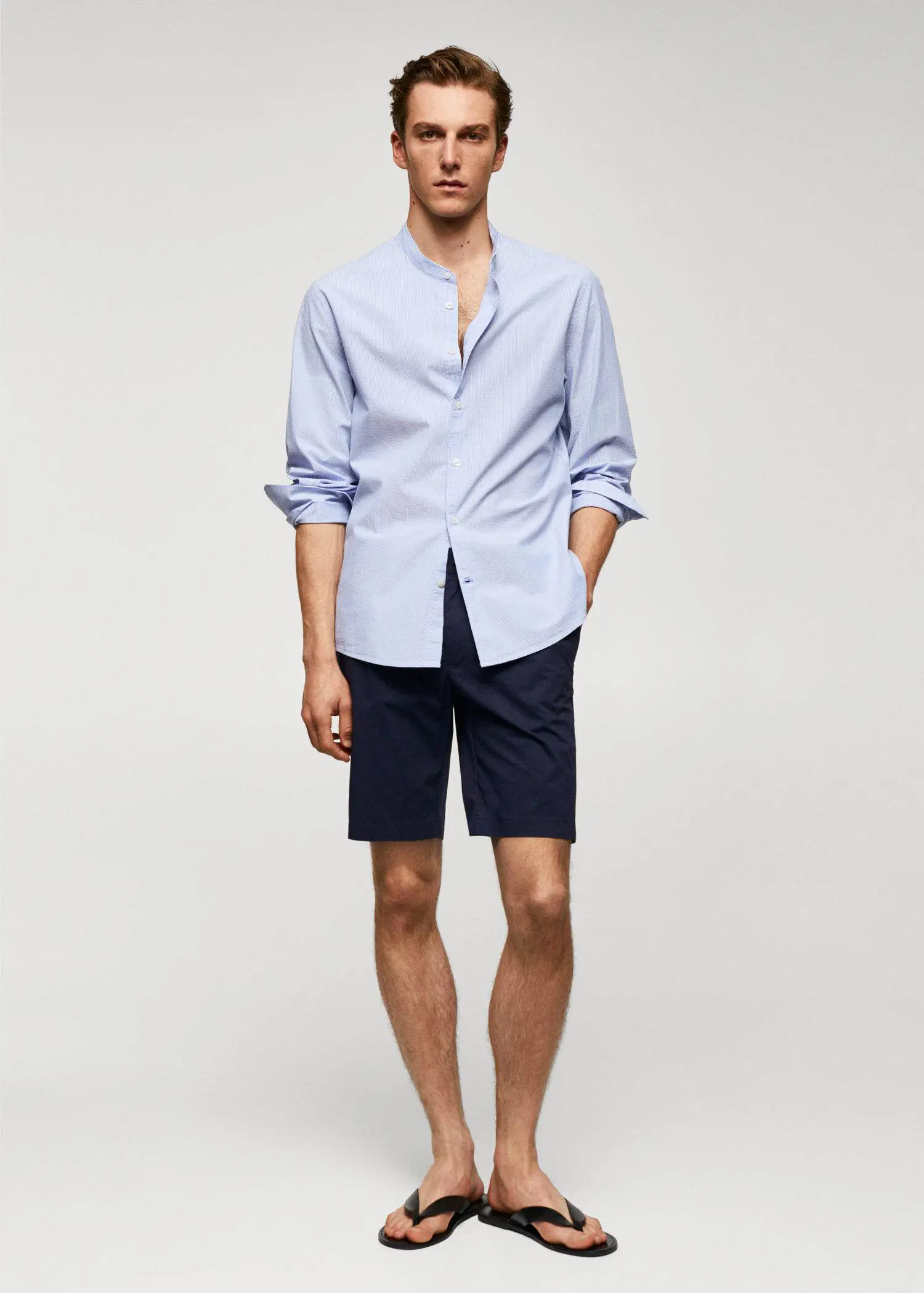 Mango Cotton seersucker shirt with multiple stripes. a man in a blue shirt and shorts. 