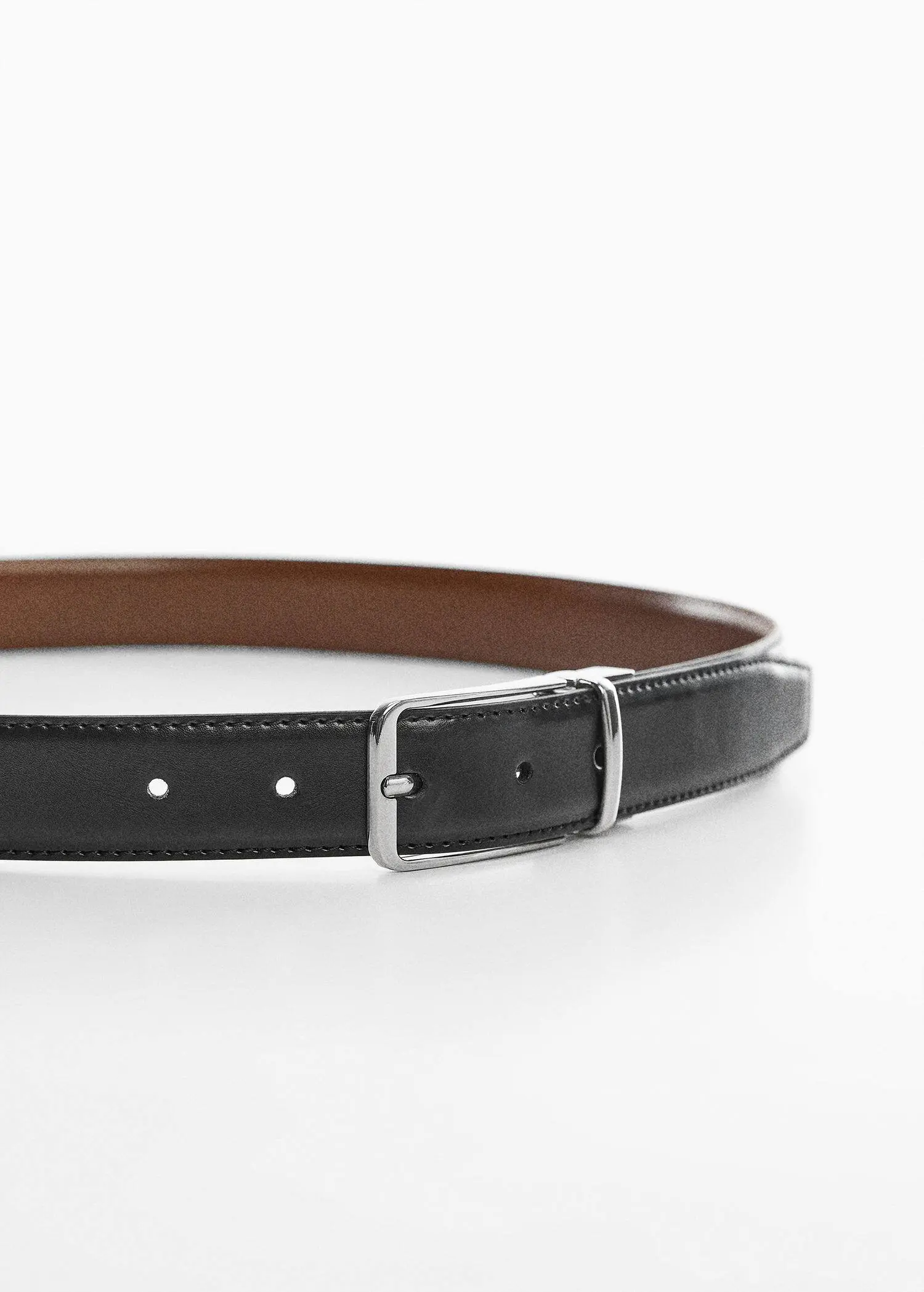 Mango Leather reversible belt. a close-up of a black belt with a silver buckle. 