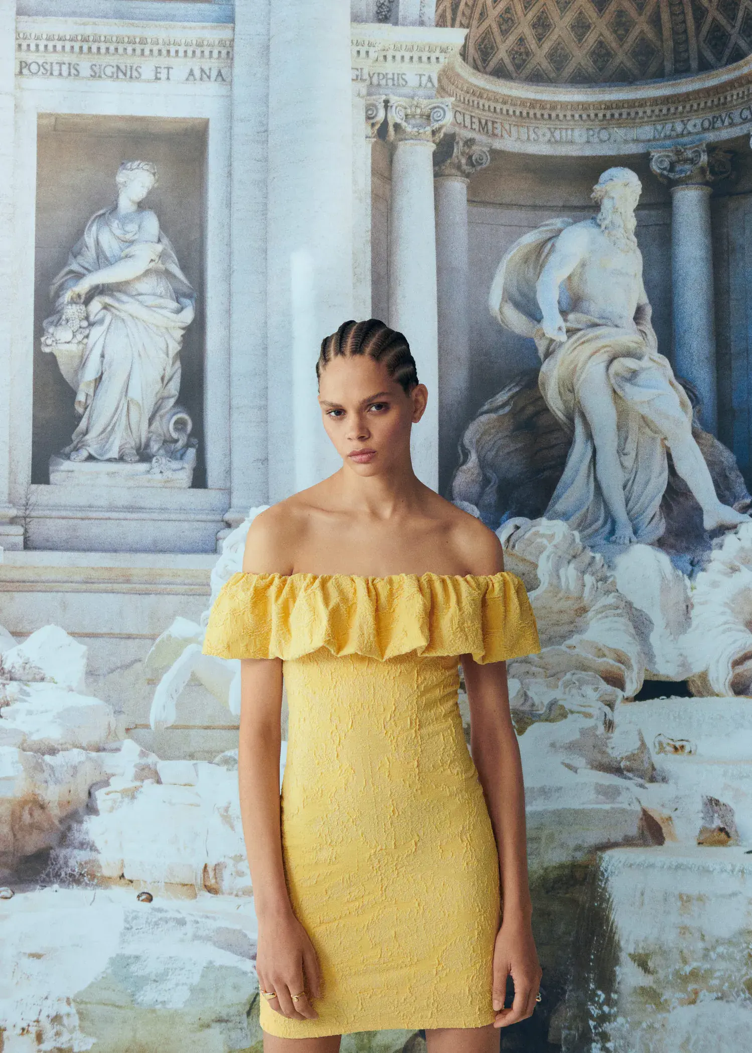 Mango Textured ruffled dress. a woman in a yellow dress standing in front of a painting. 