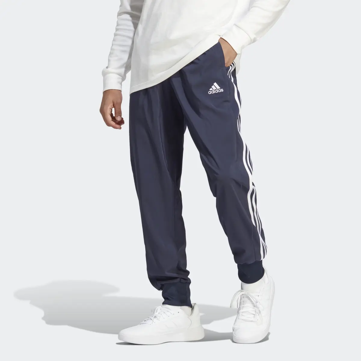 Adidas Pantalón AEROREADY Essentials Tapered Cuff Woven 3 bandas. 1