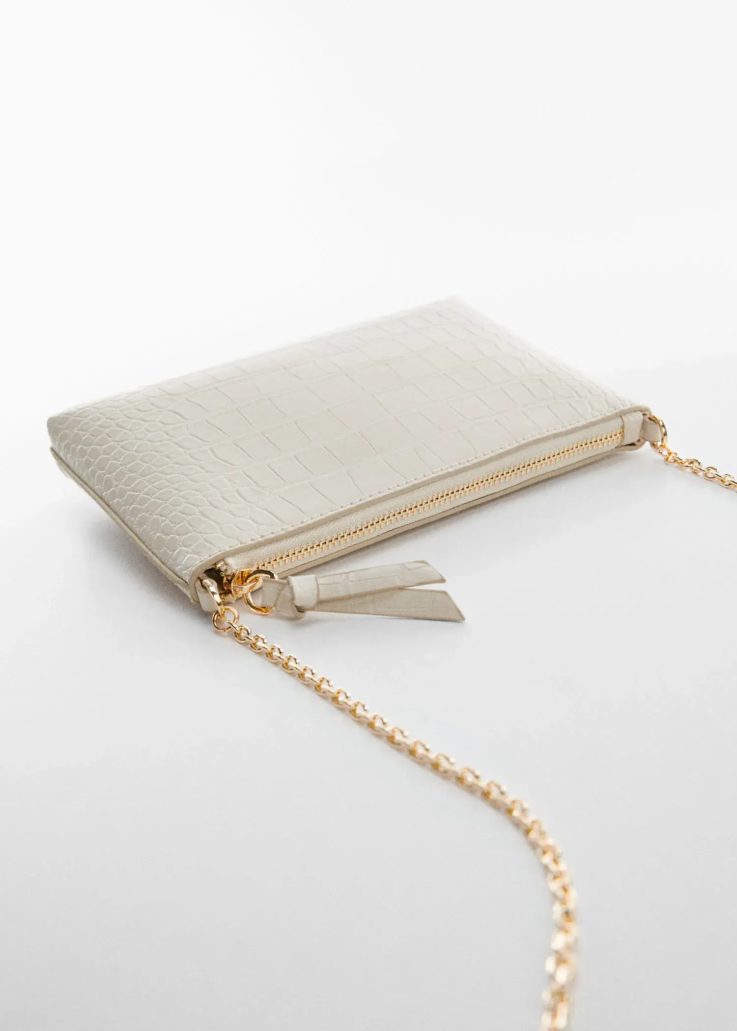 Mango Coco chain bag. a close-up of a white purse with a gold chain. 
