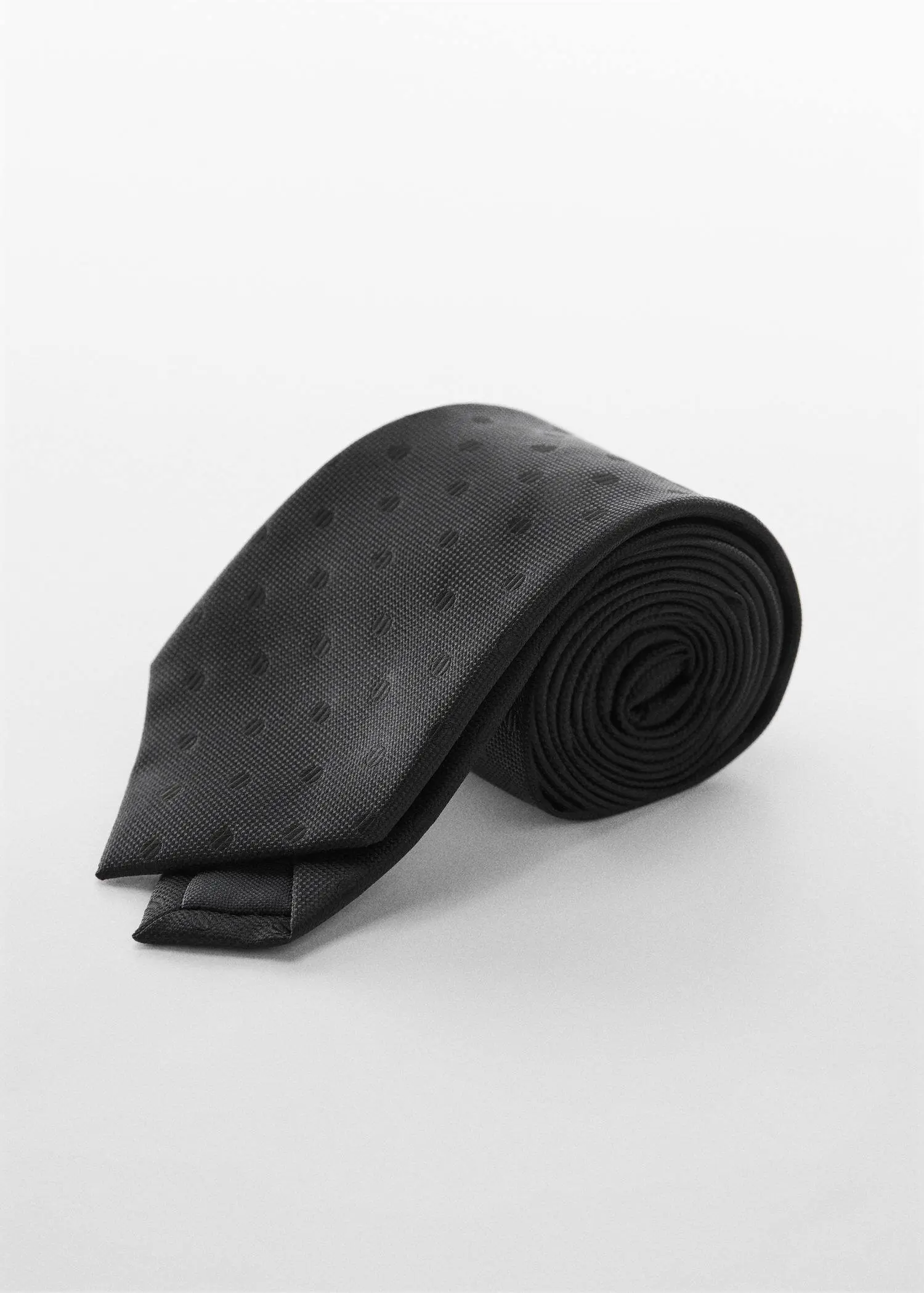 Mango Micro-print tie. a black neck tie on top of a white surface. 