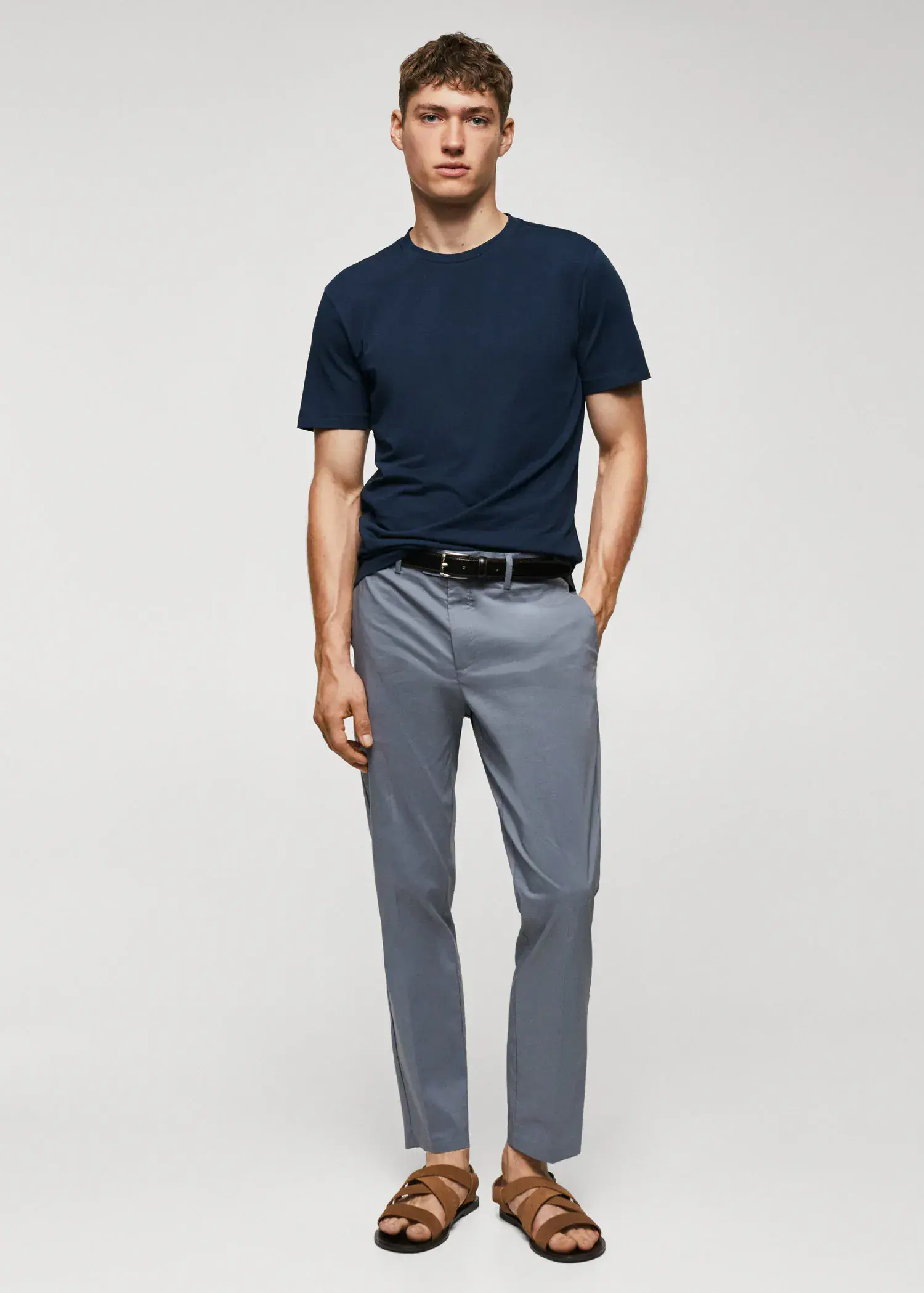 Mango Basic lightweight cotton t-shirt. a man wearing a blue shirt and gray pants. 