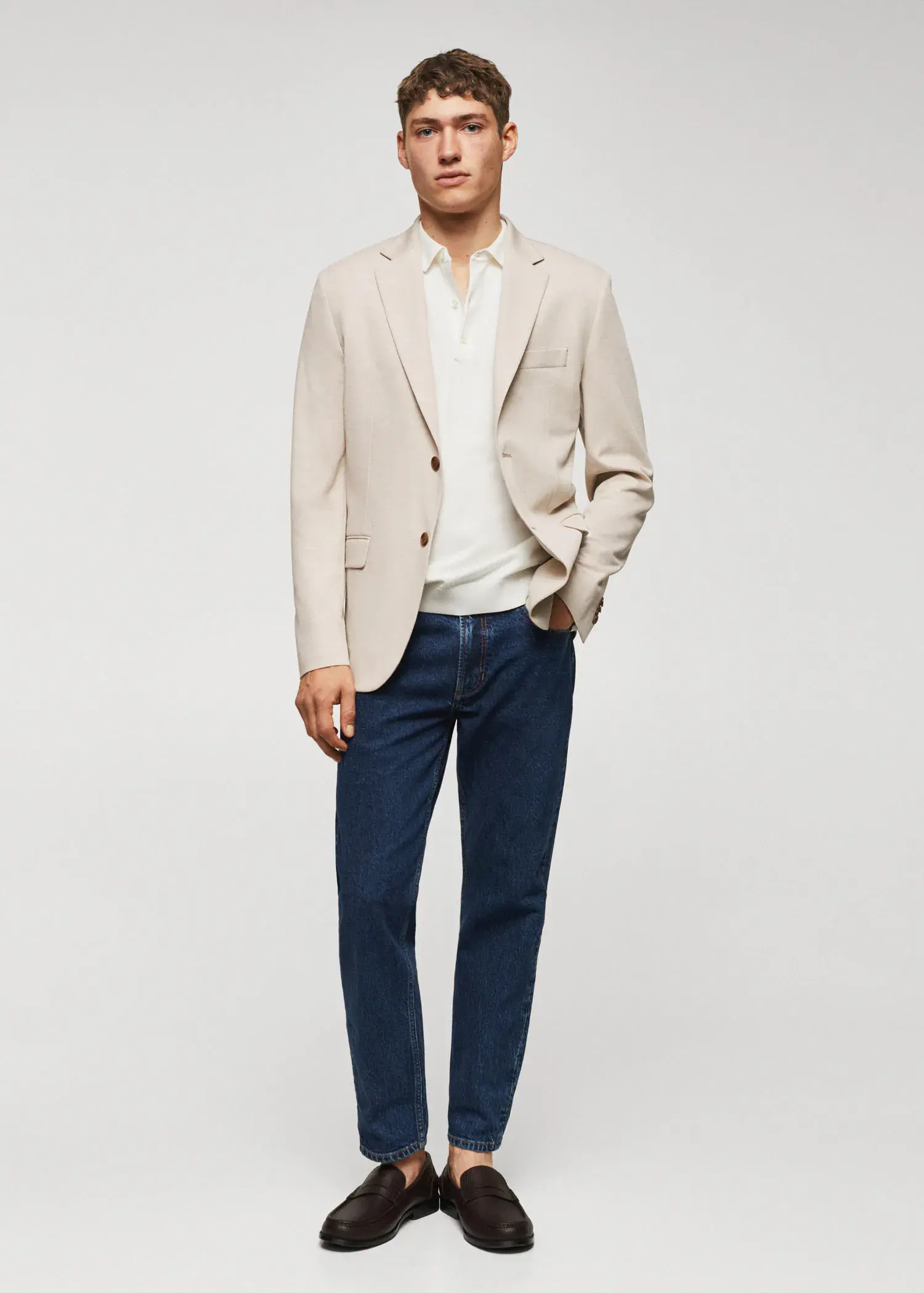 Mango Slim fit microstructure blazer. a man in a beige jacket and blue jeans. 