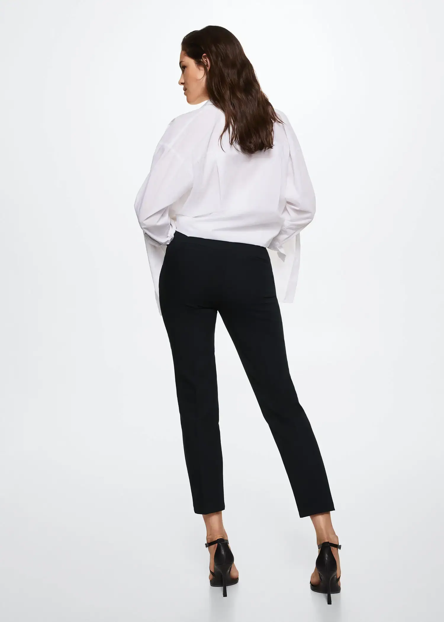 Mango Crop skinny pants. a woman wearing black pants and a white shirt. 