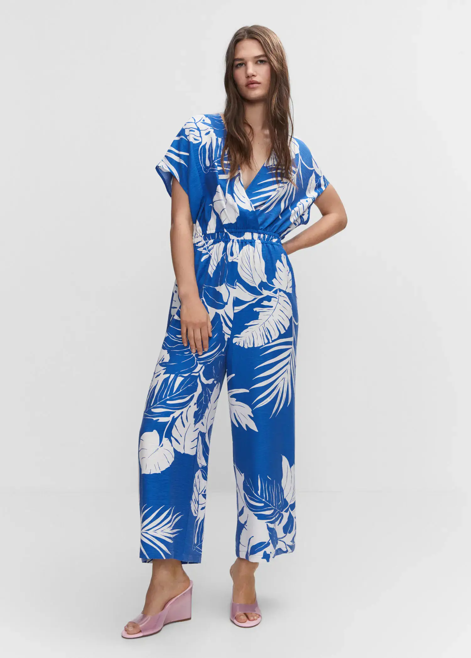 Mango Tropical print jumpsuit. a woman wearing a blue and white floral jumpsuit. 