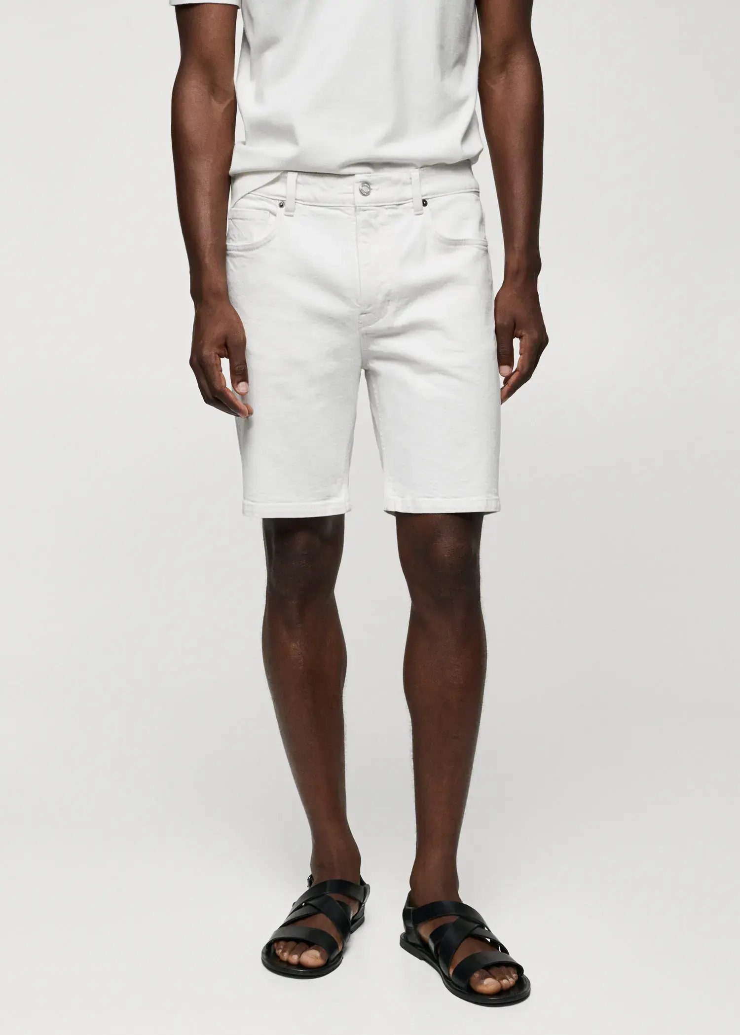 Mango Regular-fit denim bermuda shorts. a man in white shorts and a white shirt. 