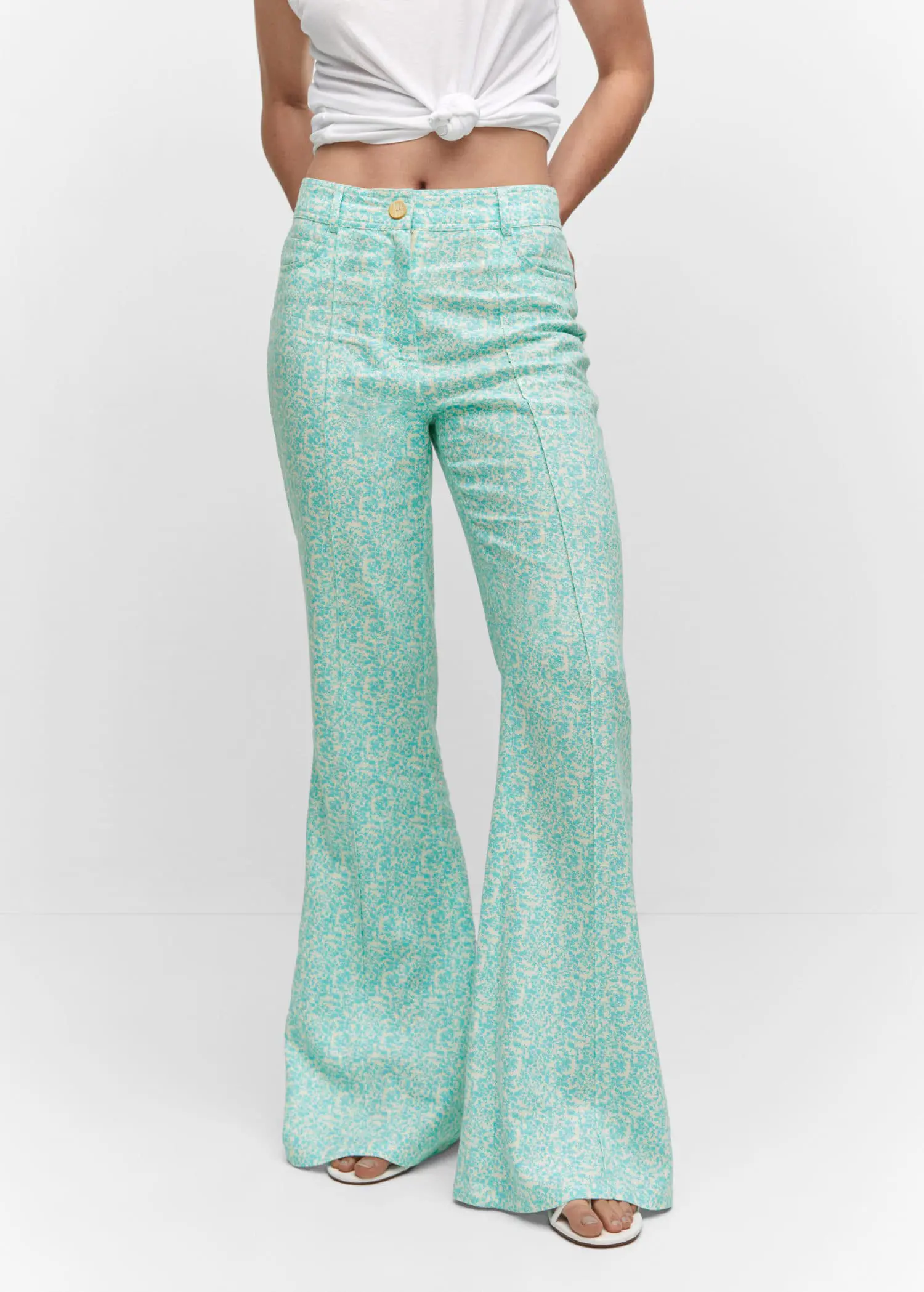 Mango Floral linen trousers. a person standing wearing a pair of pants. 