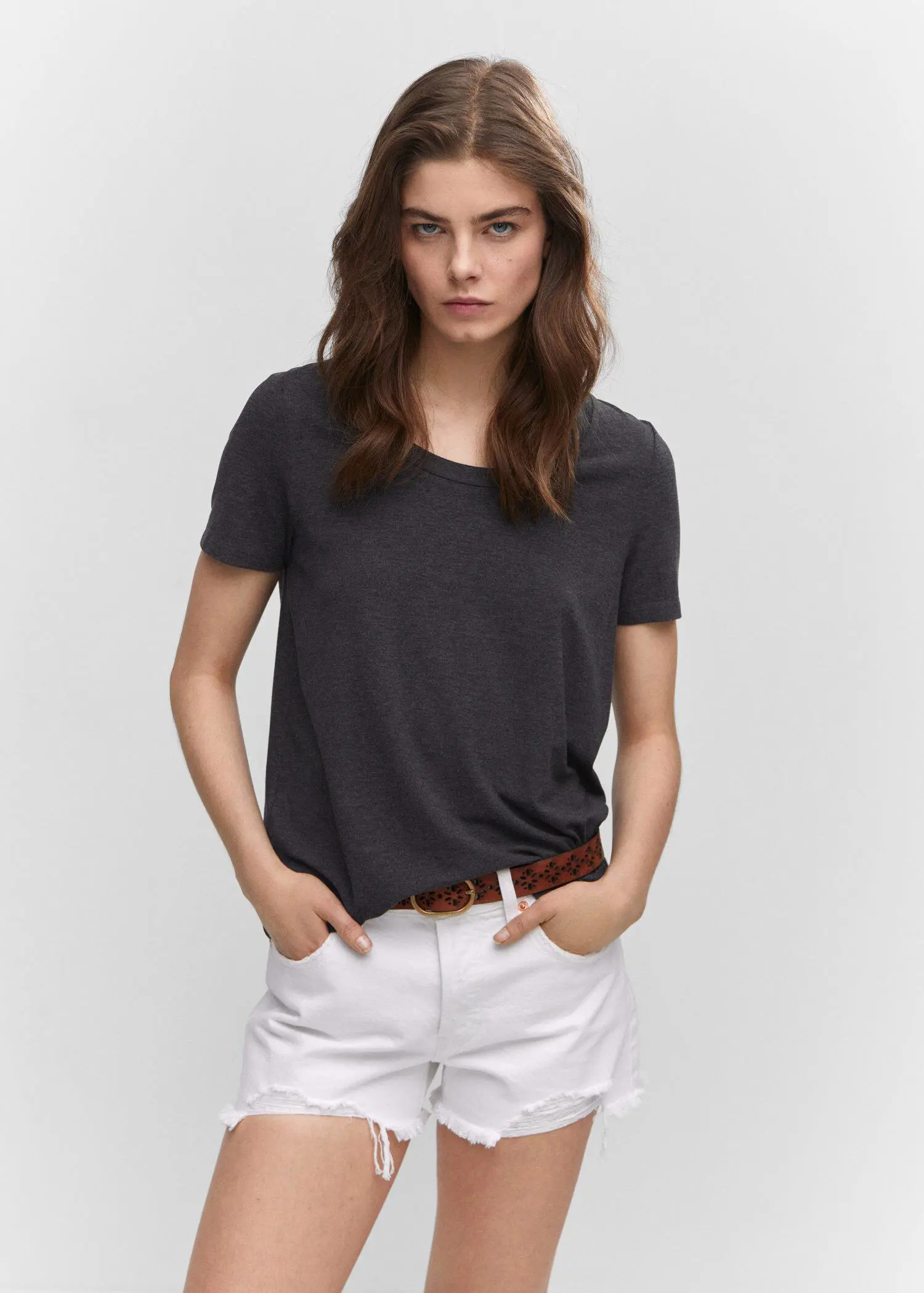 Mango Short sleeve t-shirt. a woman wearing white shorts and a black t-shirt. 