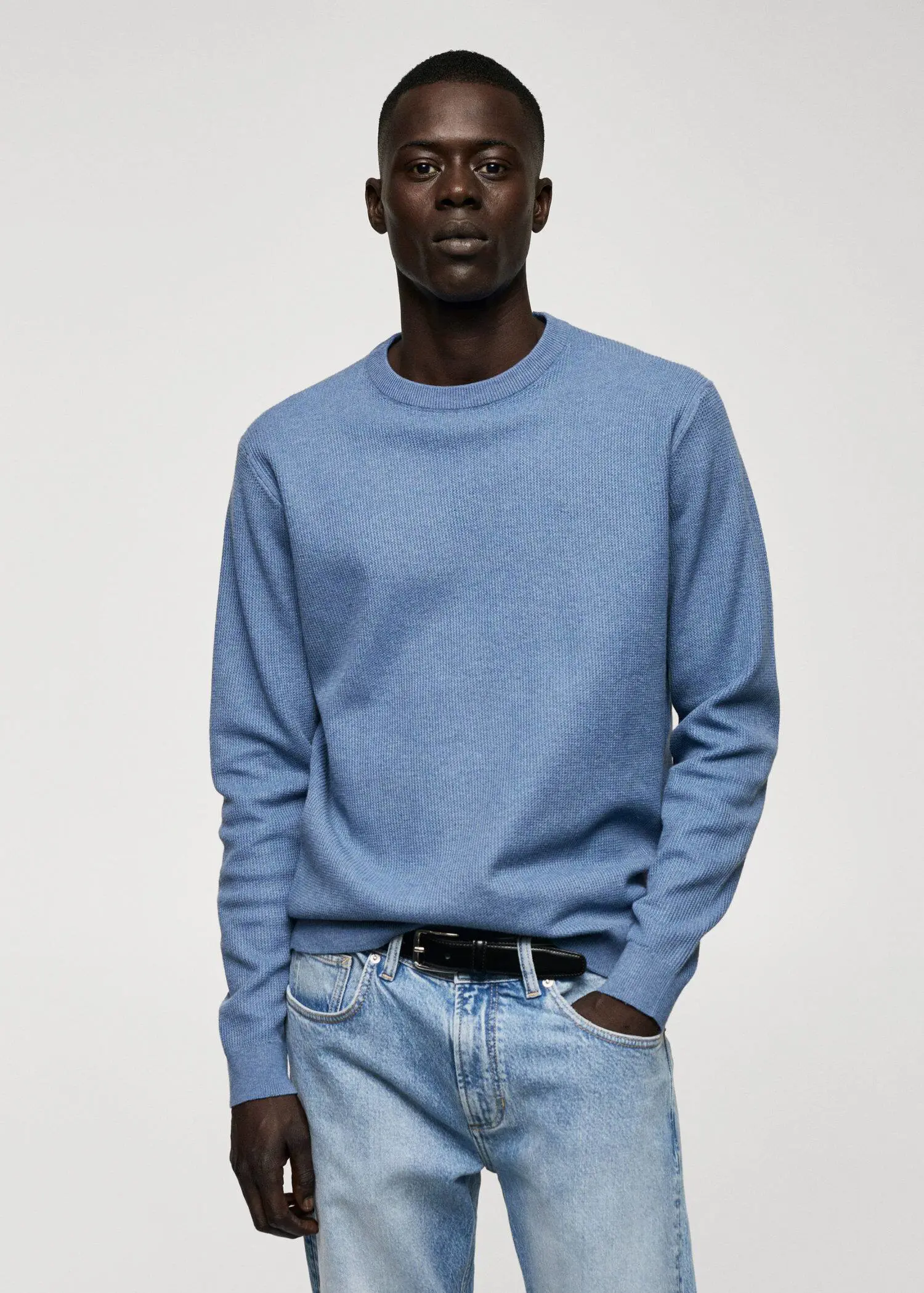 Mango Structured cotton sweater. a man wearing a blue sweater and jeans. 