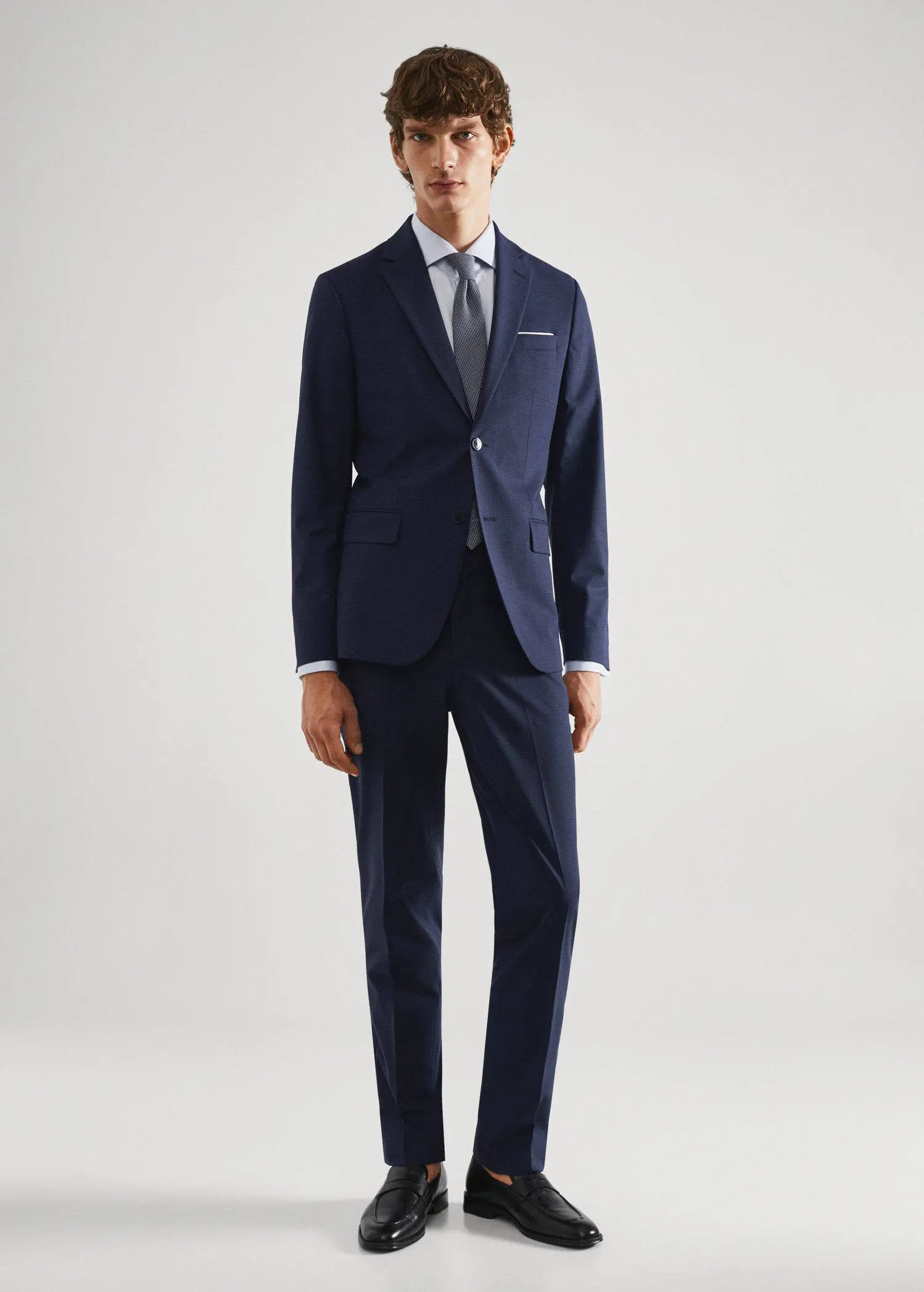 Mango Slim-fit check wool suit blazer. a man wearing a suit and tie standing in a room. 