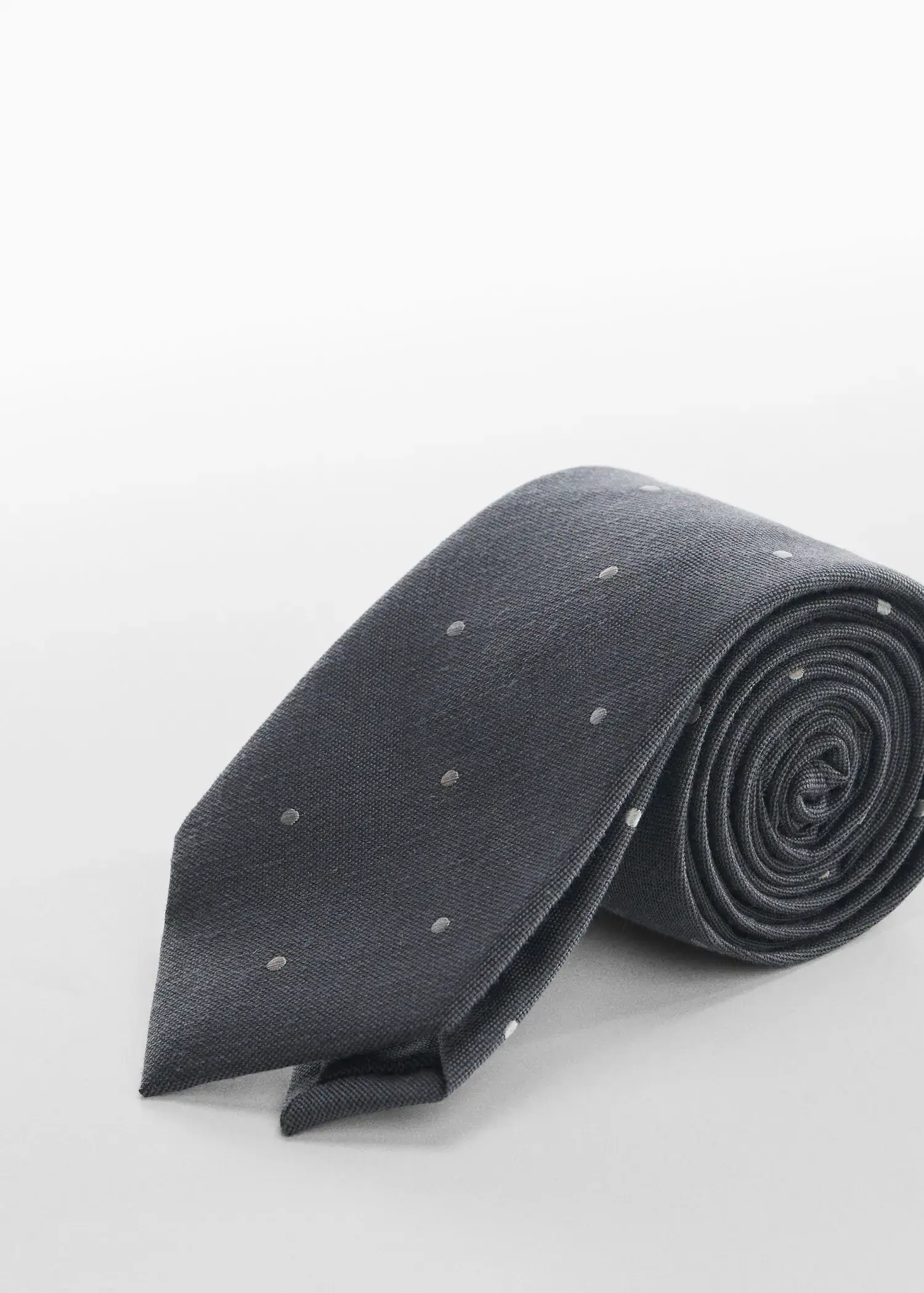 Mango Polka-dot patterned tie. a black tie with white polka dots on it. 