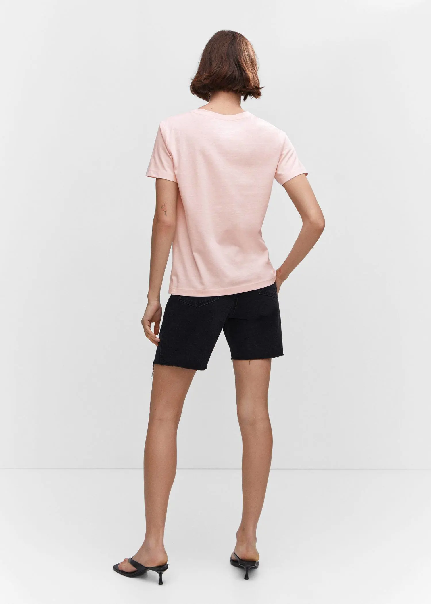 Mango 100% cotton T-shirt. a person wearing black shorts and a light pink shirt. 