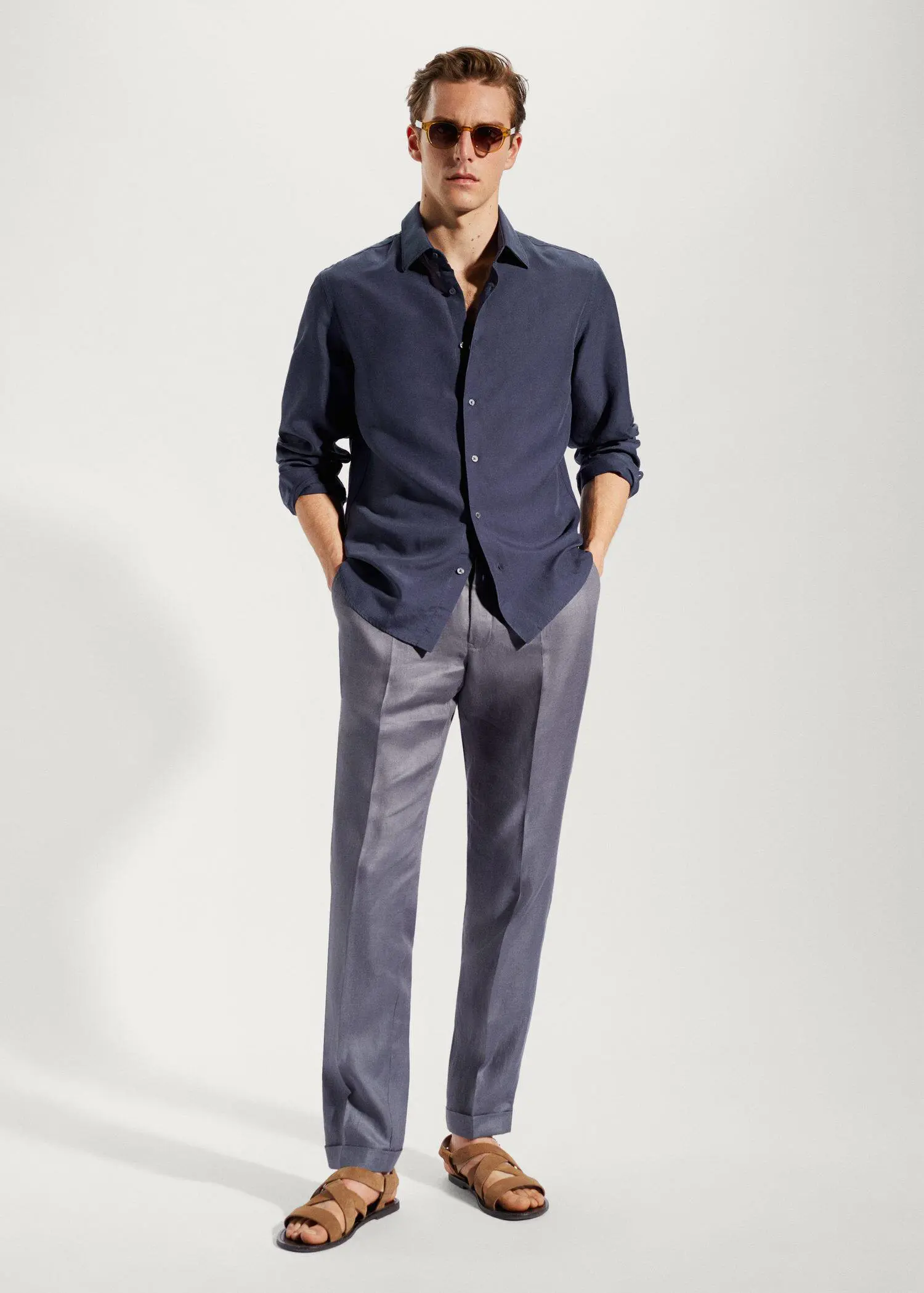Mango Light tencel-linen shirt. a man wearing a blue shirt and gray pants. 