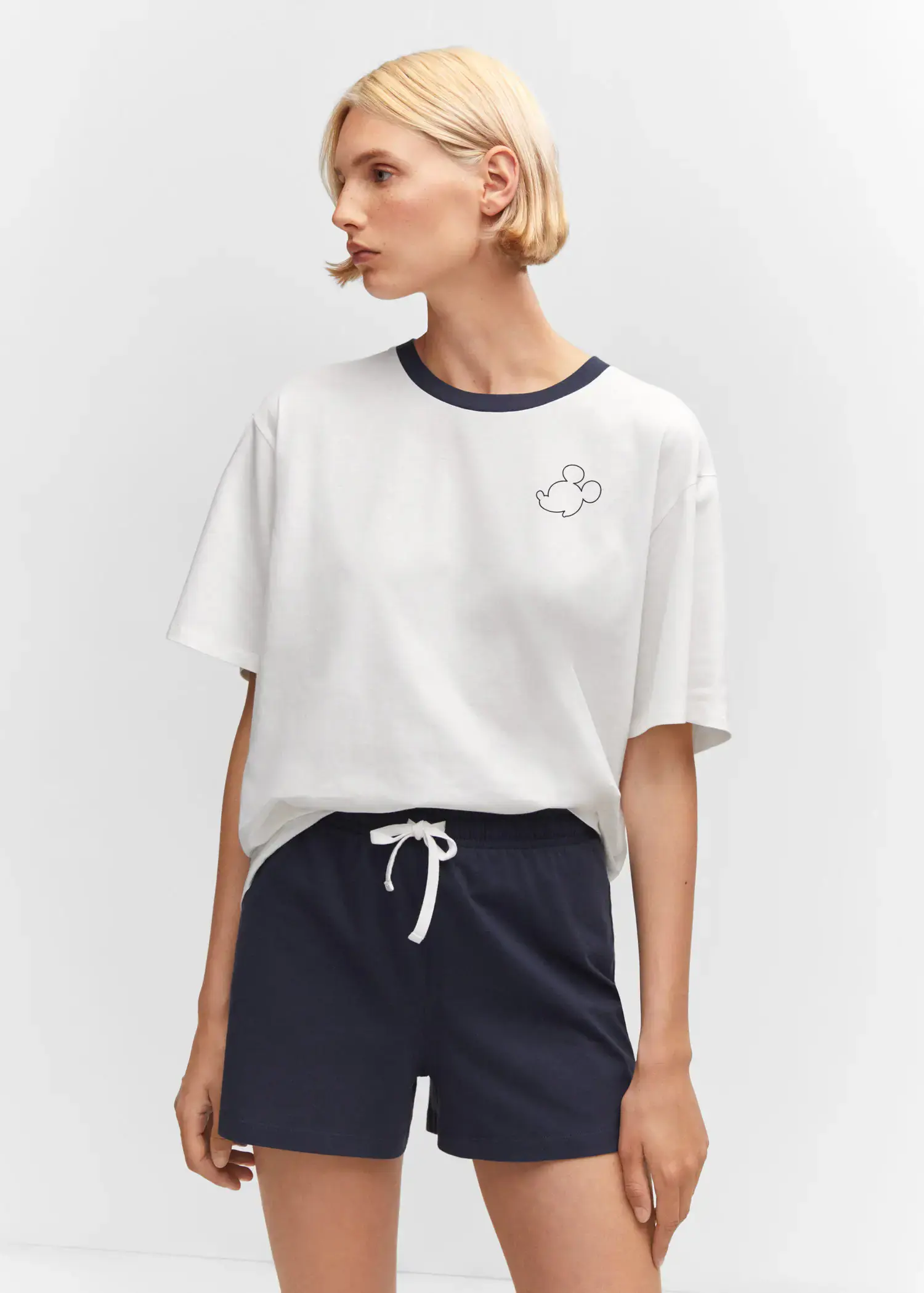 Mango Cotton shorts with elastic waist. a woman wearing a white t-shirt and navy blue shorts. 