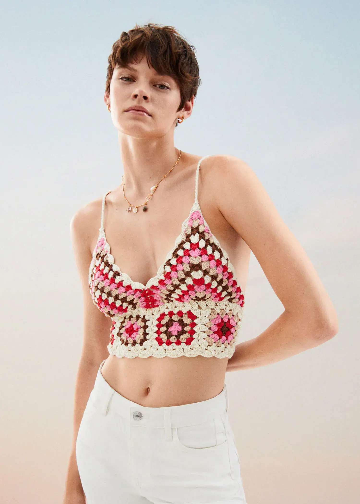 Mango Crochet crop top. a young woman wearing a crocheted bra top. 