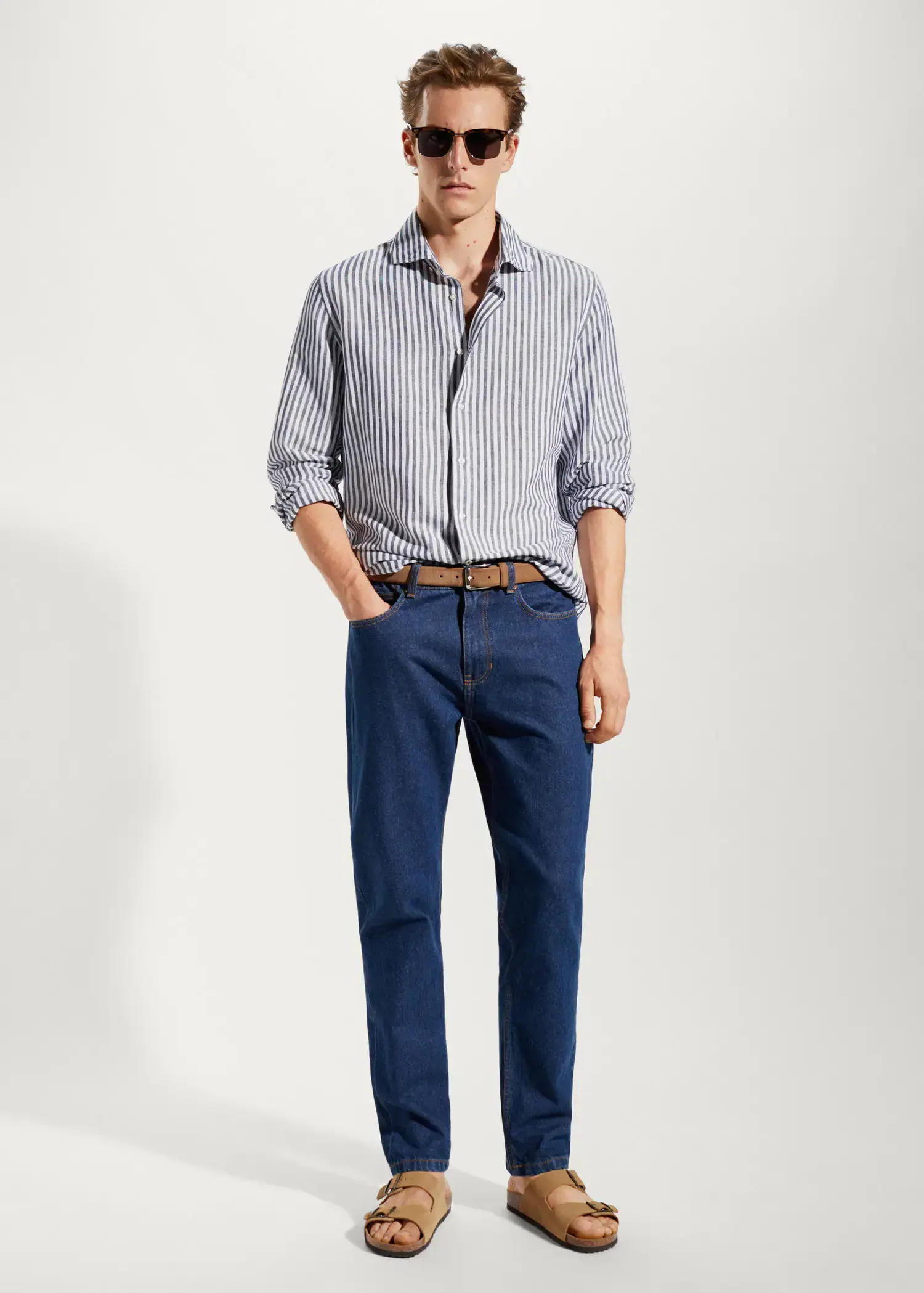 Mango Slim fit striped linen shirt. a man in a striped shirt and blue jeans. 