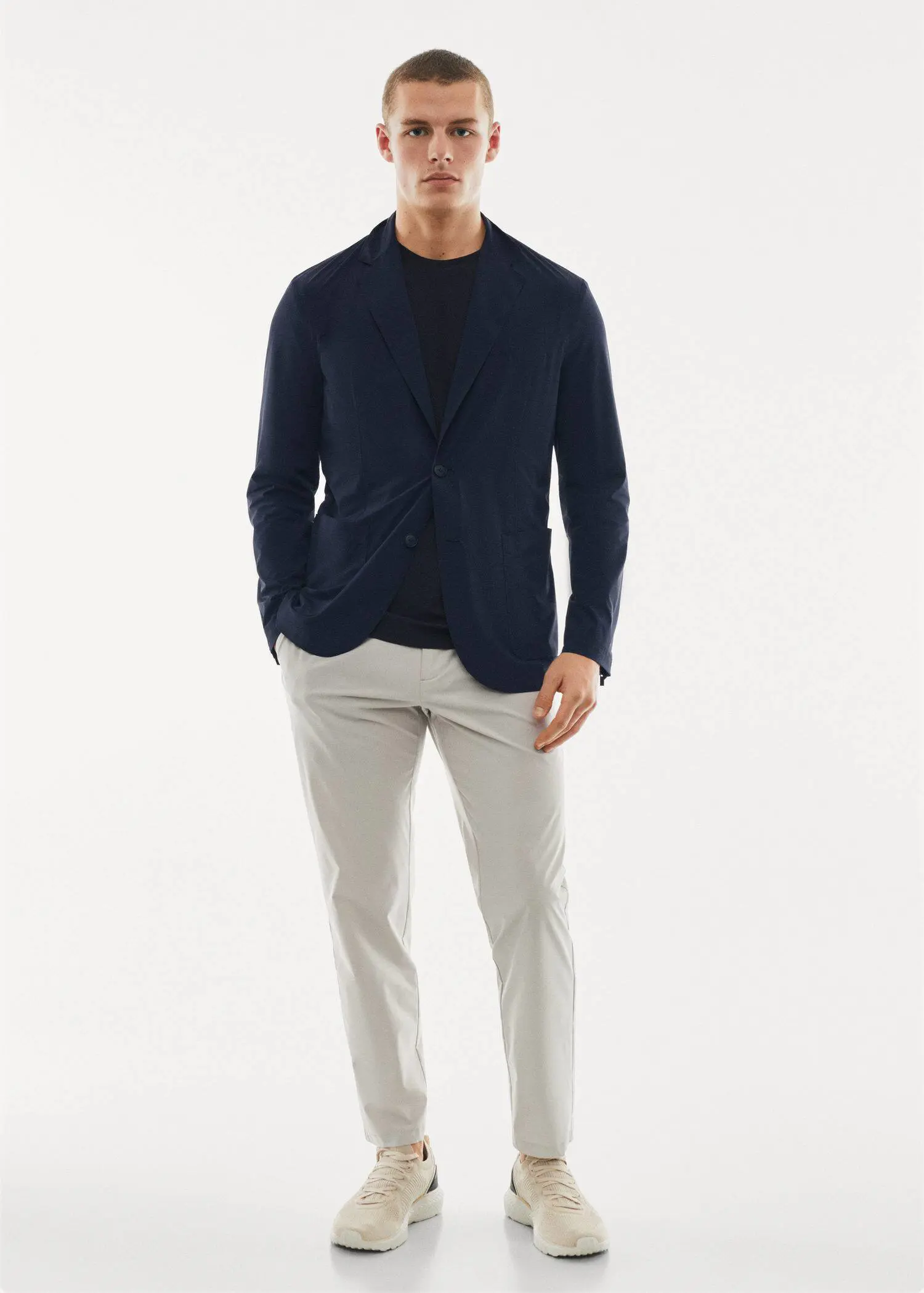Mango Lightweight water-repellent jacket. a man in a black jacket and white pants. 