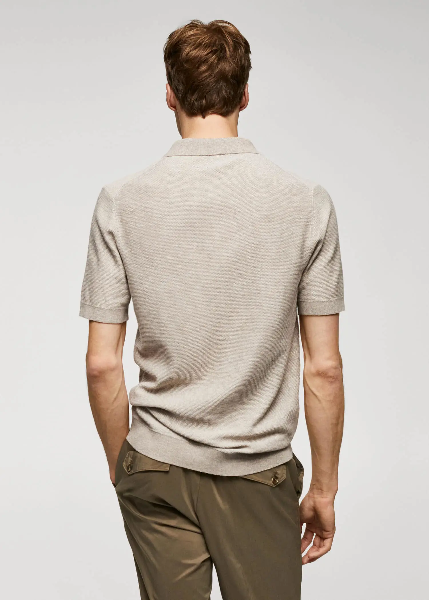 Mango Patterned cotton polo shirt. a man in a tan polo shirt is standing. 