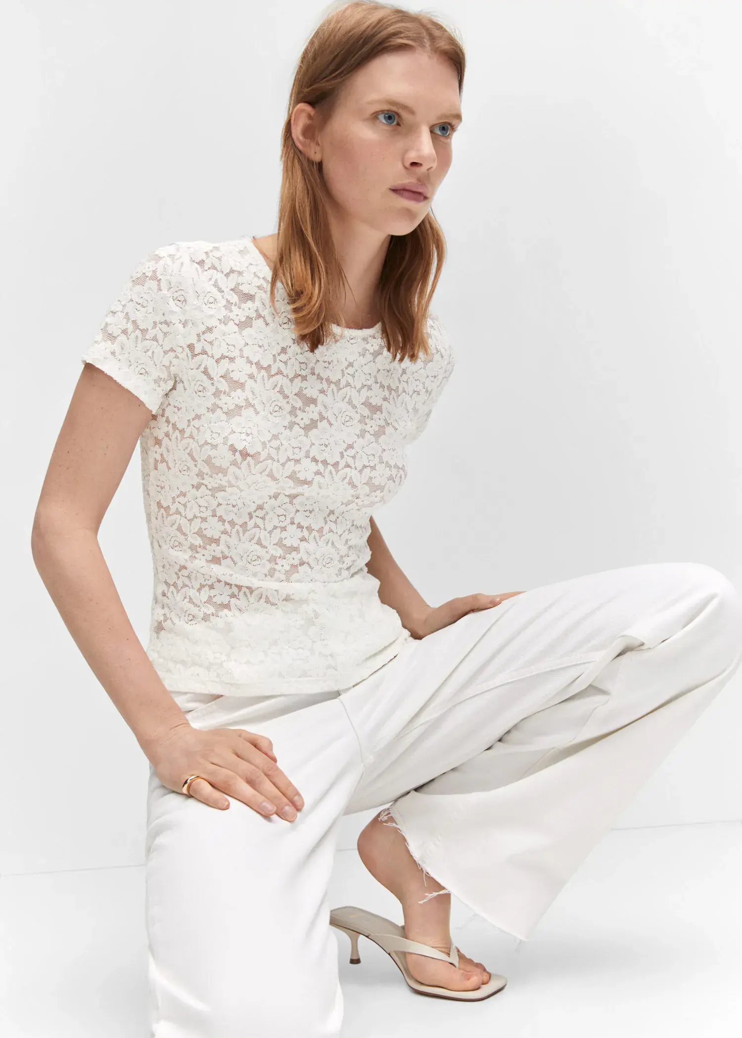 Mango Guipure T-shirt. a woman sitting on the ground wearing all white. 