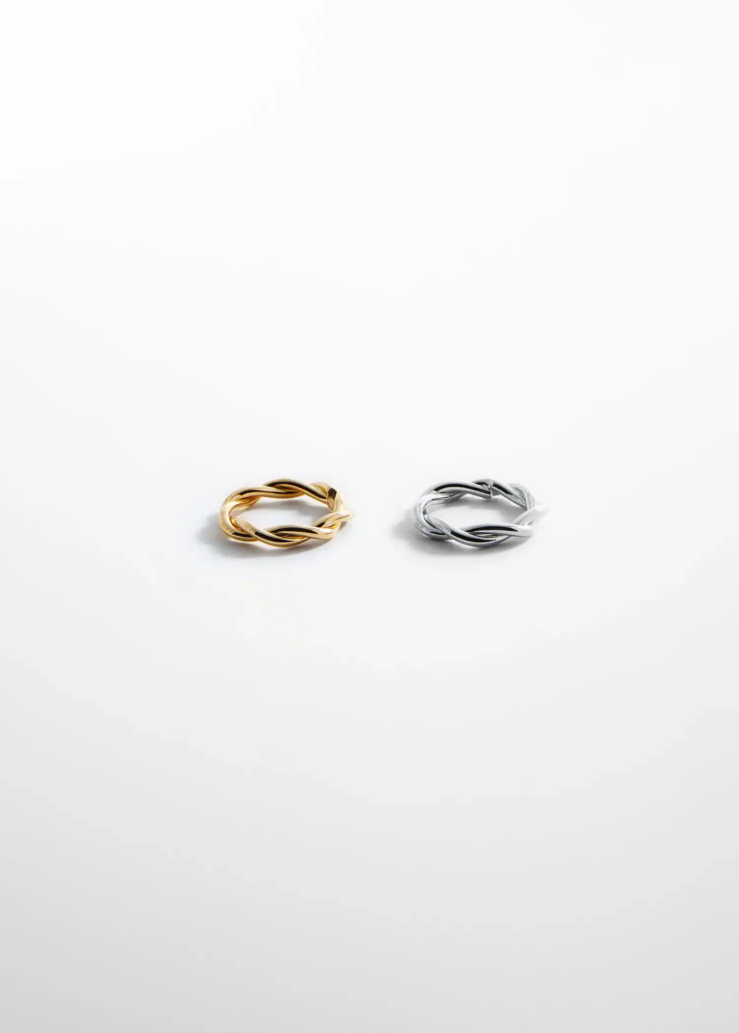 Mango Criss-cross 2 ring set. a pair of gold and silver rings on top of each other. 