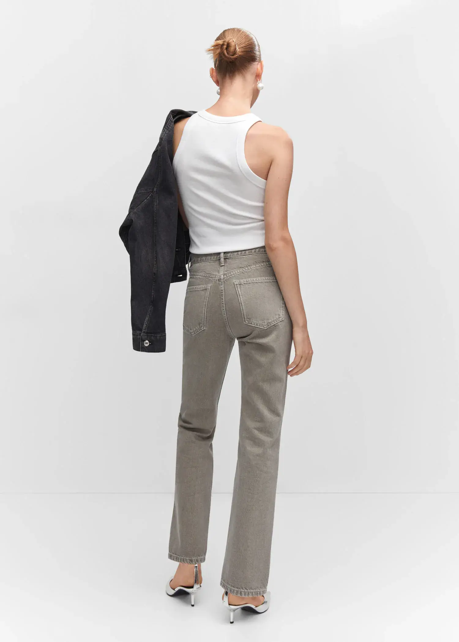 Mango Ribbed cotton-blend top. a woman in a white shirt and gray pants holding a jacket. 