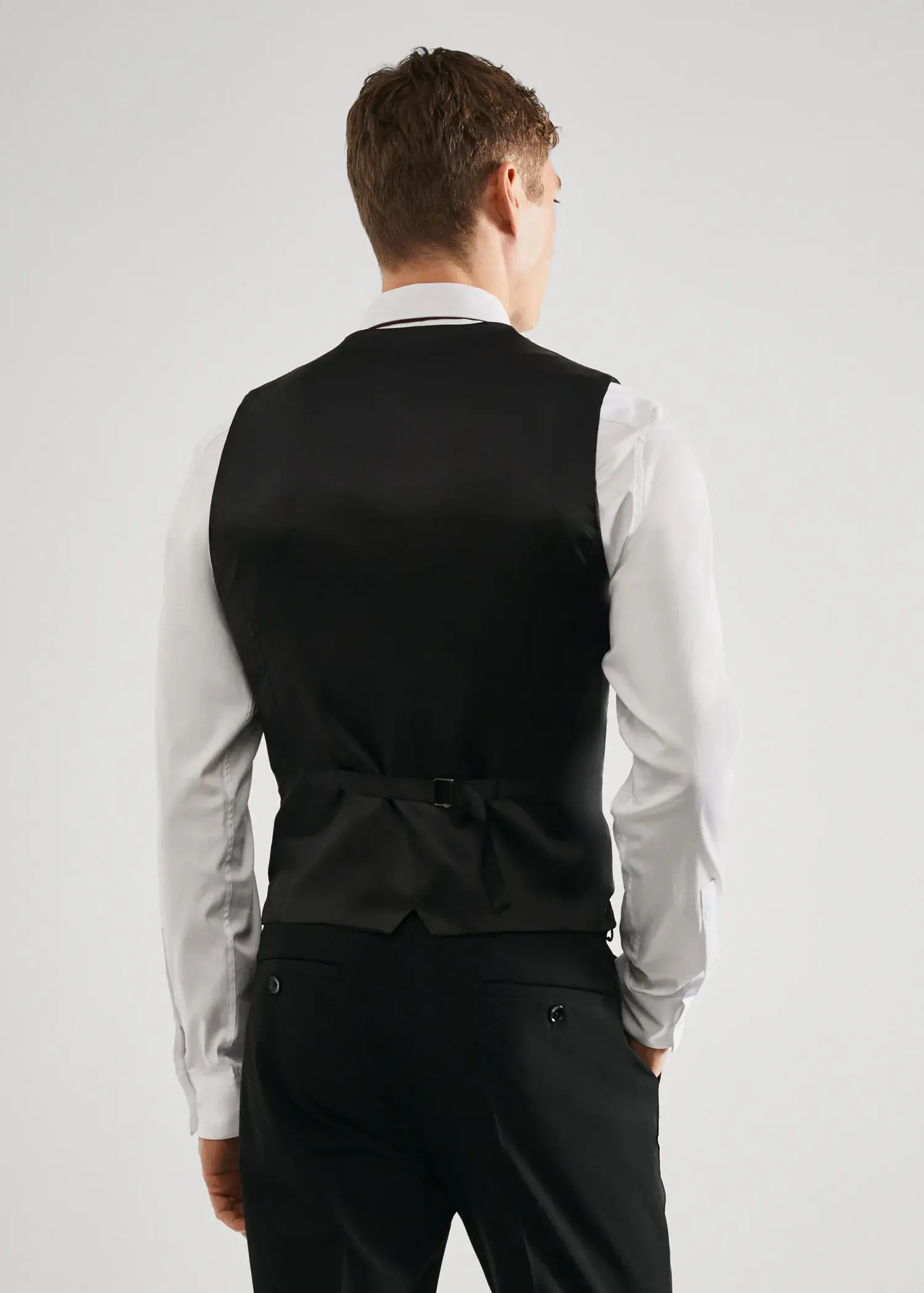 Mango Super slim-fit stretch fabric suit vest. a man wearing a black suit and white shirt. 