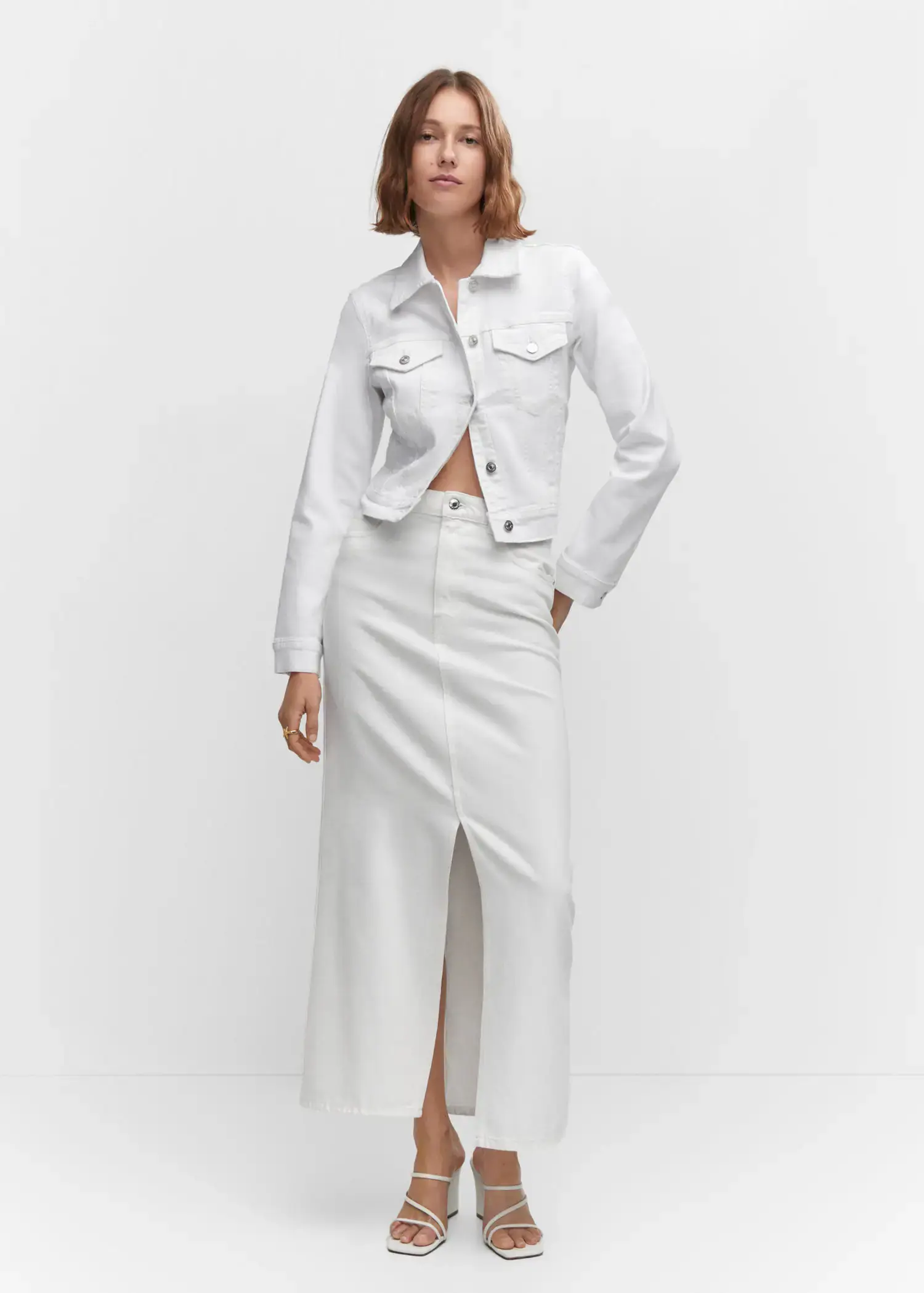 Mango Pocketed denim jacket. a woman wearing a white outfit standing in front of a white wall. 