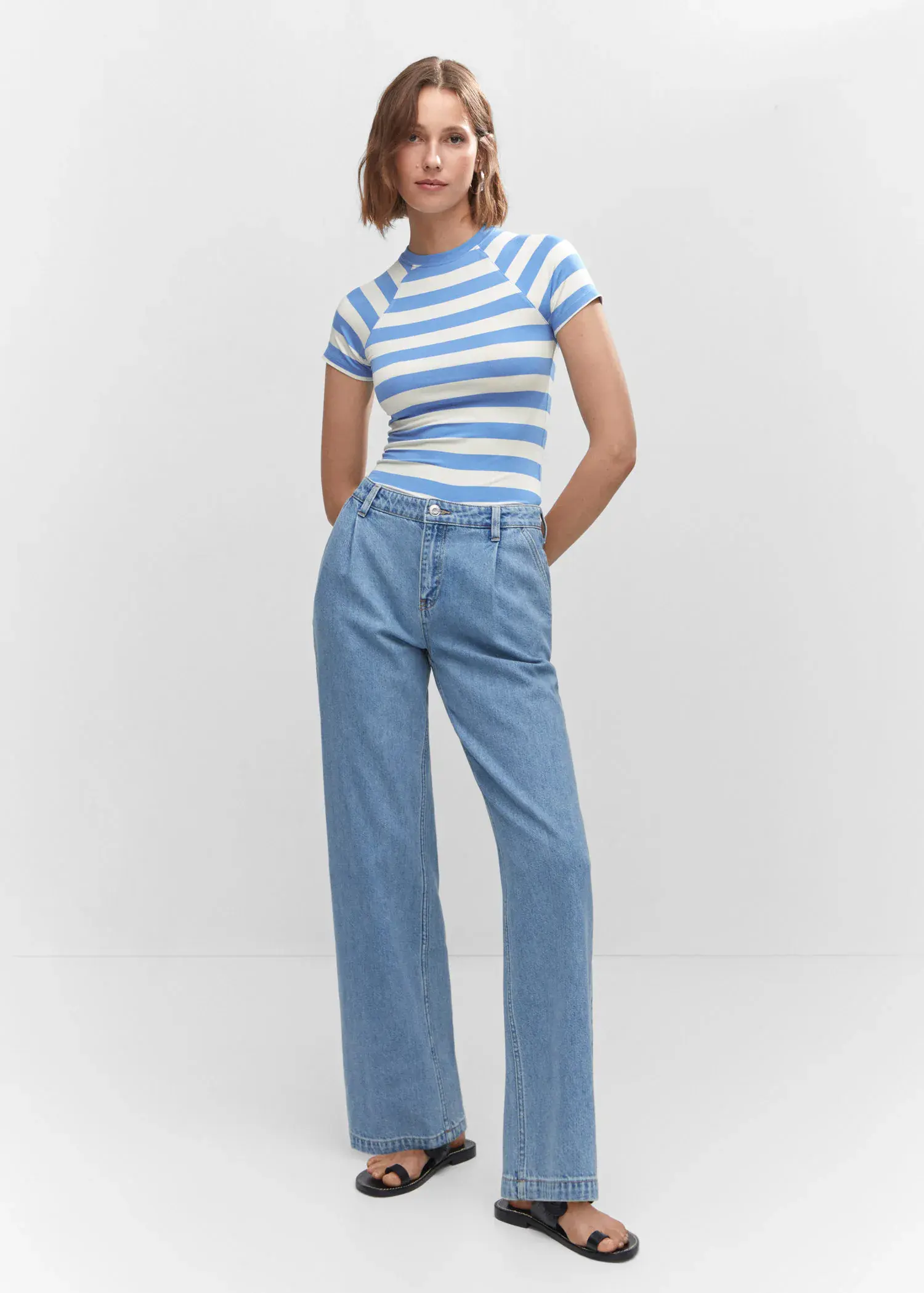 Mango Striped print T-shirt. a woman wearing a striped shirt and jeans. 