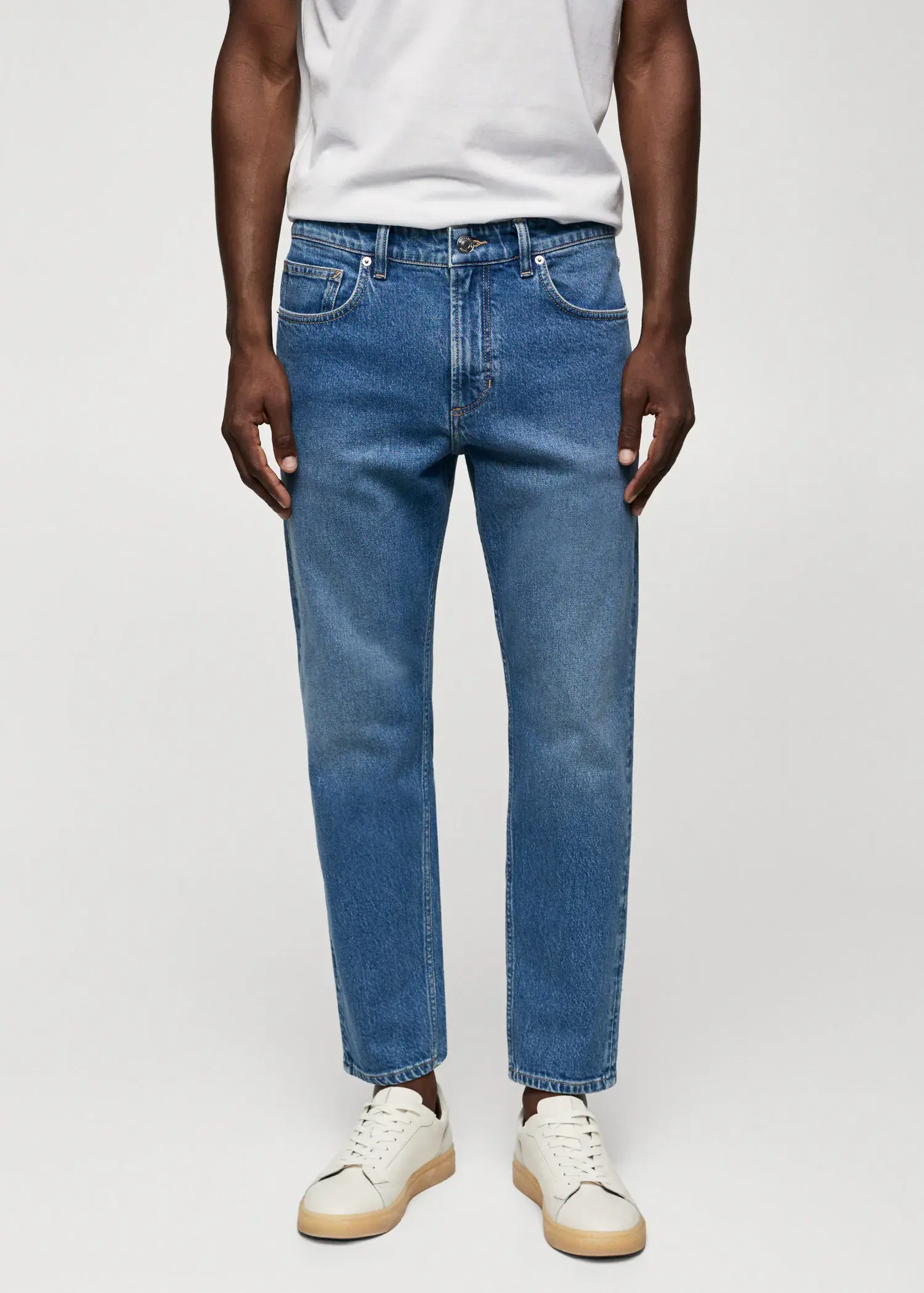 Mango Ben tapered cropped jeans. a person wearing a pair of blue jeans. 