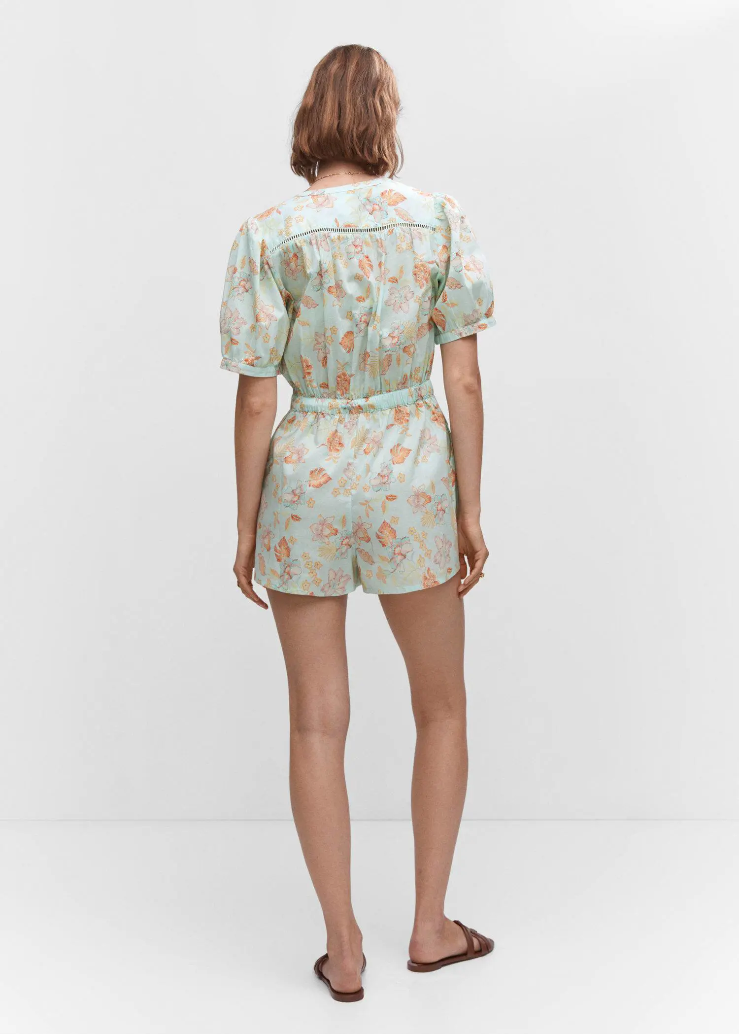 Mango Floral short jumpsuit. a person wearing a short sleeve shirt and shorts. 
