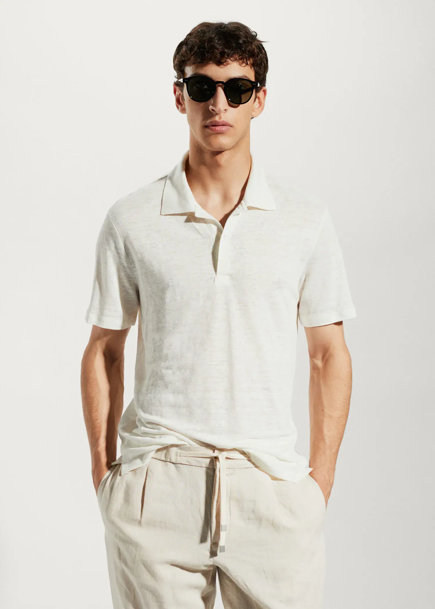 Mango Slim fit 100% linen polo shirt. a man wearing a white shirt and sunglasses. 