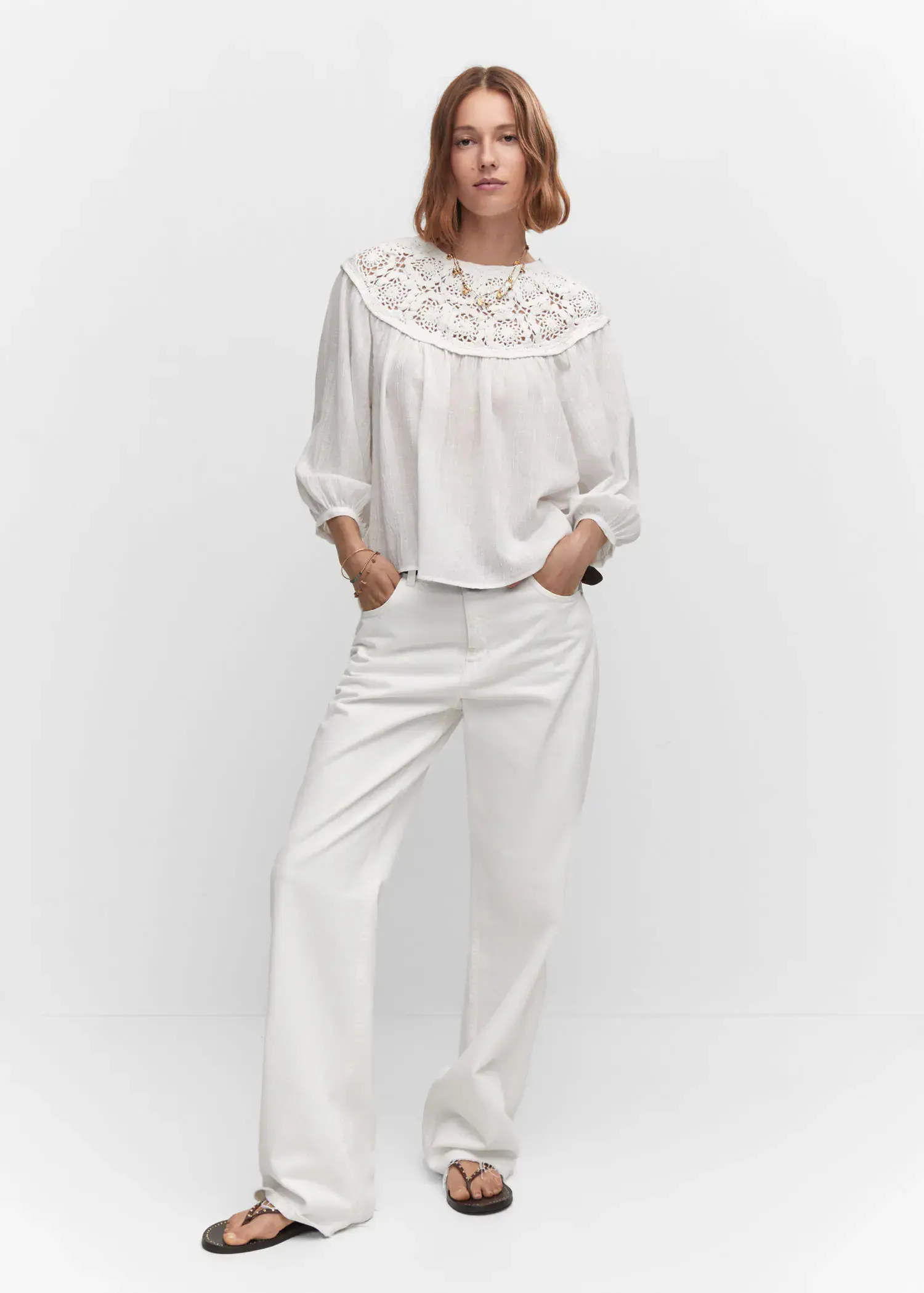 Mango Crochet panel blouse. a woman in a white outfit standing in front of a wall. 