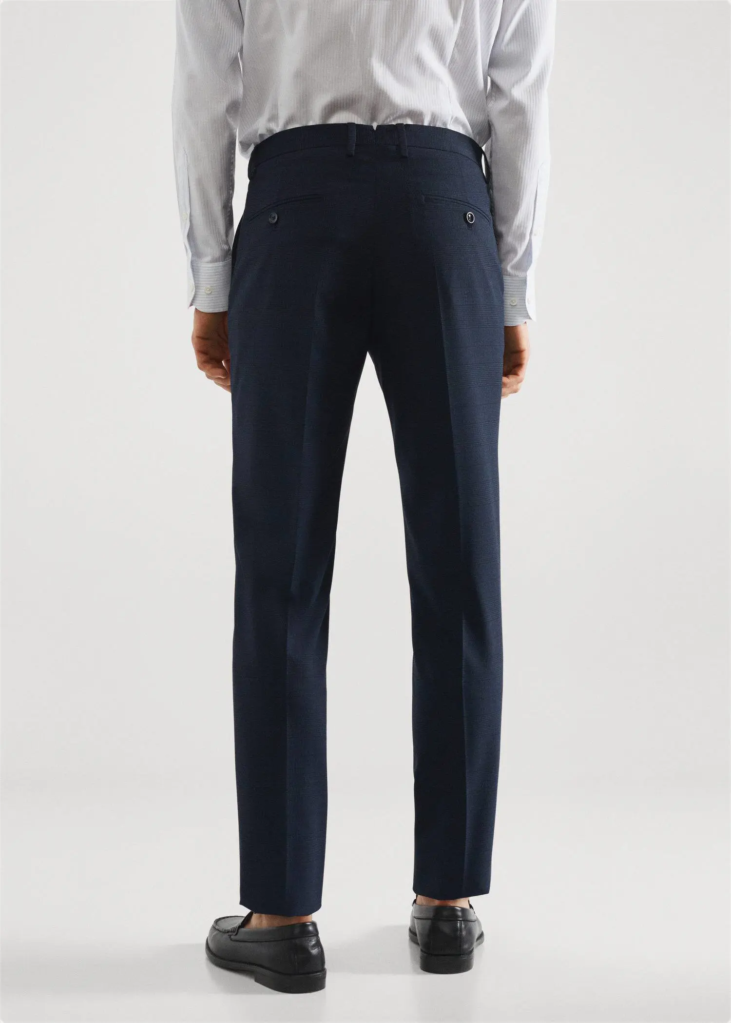 Mango Stretch fabric slim-fit printed suit trousers. a man wearing a suit standing next to a wall. 